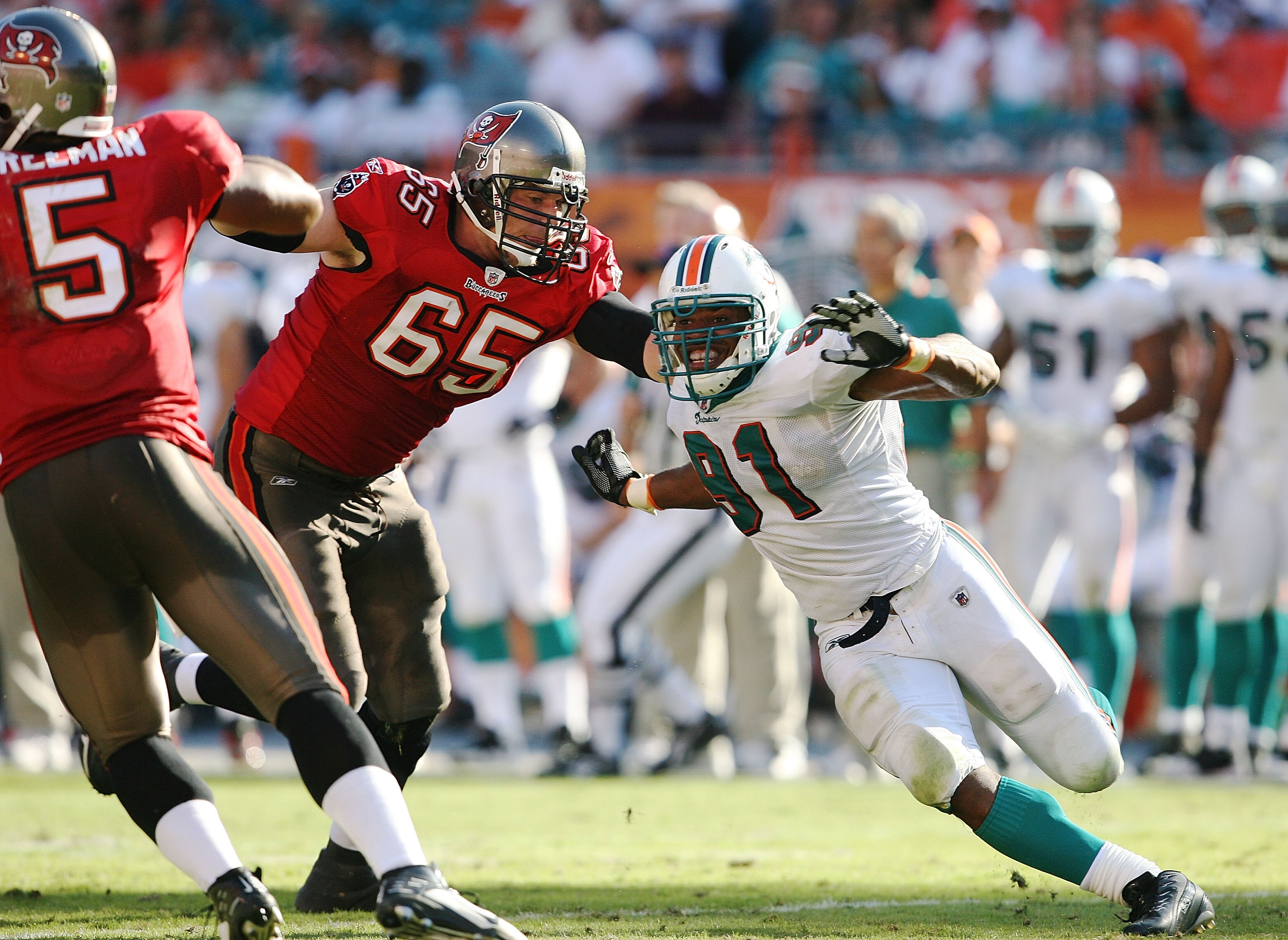 MIAMI GARDENS, FL - NOVEMBER 15:  Tackle Jeremy Trueblood #65 of the Tampa Bay Buccaneers tries to keep linebcker Cameron Wake #91 of the Miami Dolphins from getting to quarterback Josh Freeman #5 at Land Shark Stadium on November 15, 2009 in Miami Garden