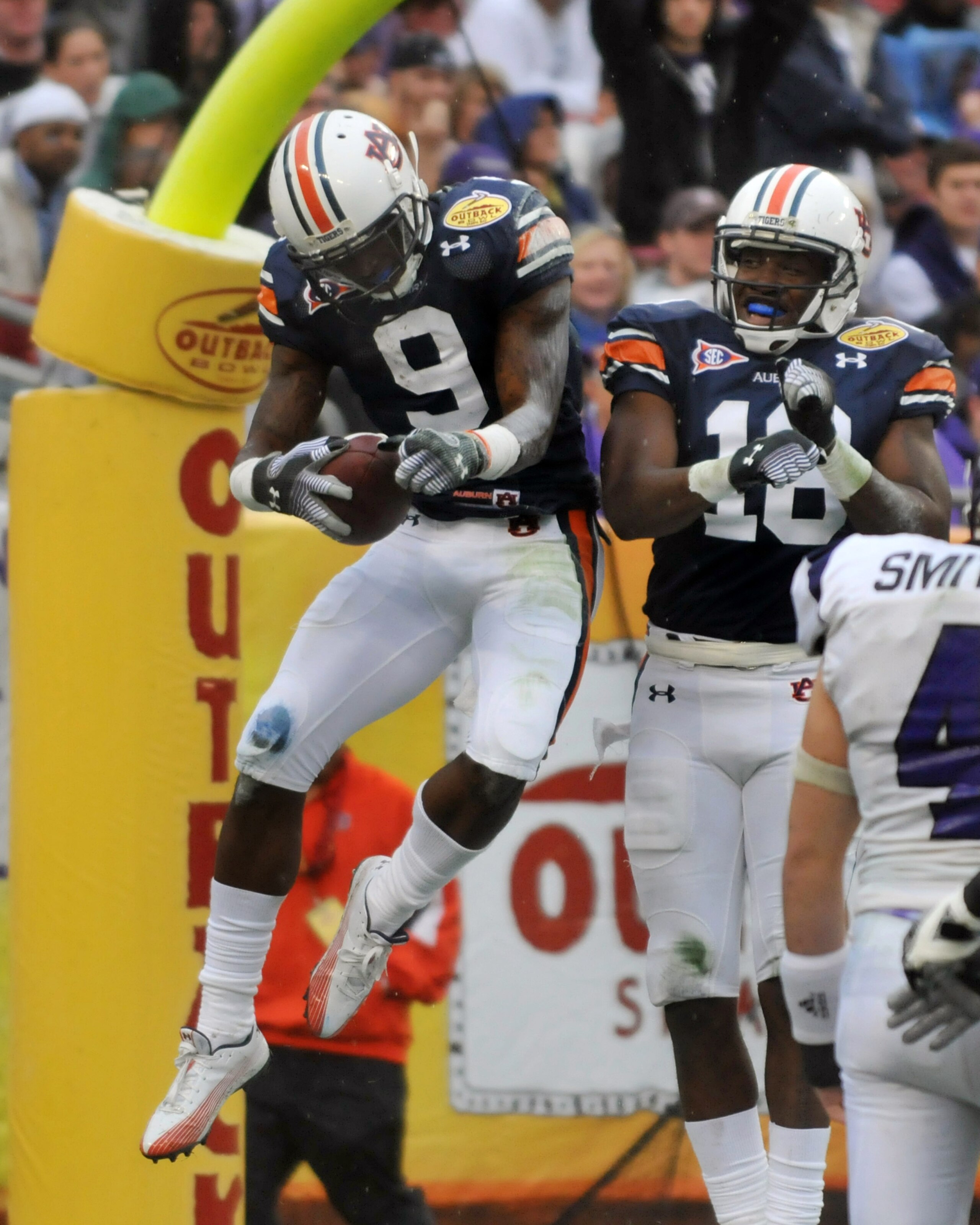 TAMPA, FL - JANUARY 1: Wide receiver Quindarius Carr #9 of the Auburn Tigers celebrates a touchdown against the Northwestern Wildcats in the Outback Bowl January 1, 2010 at Raymond James Stadium in Tampa, Florida.  (Photo by Al Messerschmidt/Getty Images)