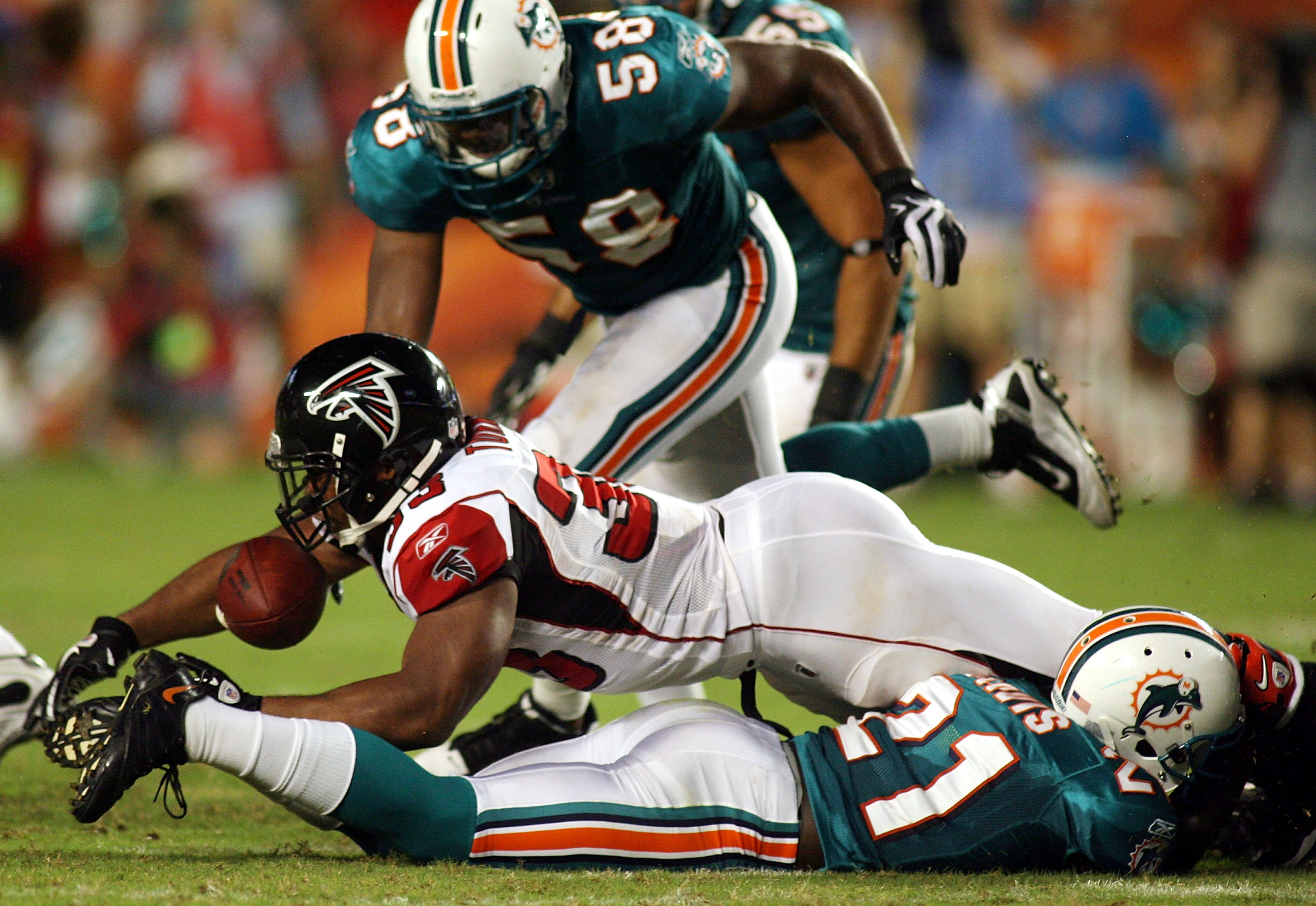 MIAMI - AUGUST 27: Running back Michael Turner #33 of the Atlanta Falcons fumbles against the Miami Dolphins during their preseason game at Sun Life Stadium on August 27, 2010 in Miami, Florida.  (Photo by Marc Serota/Getty Images)
