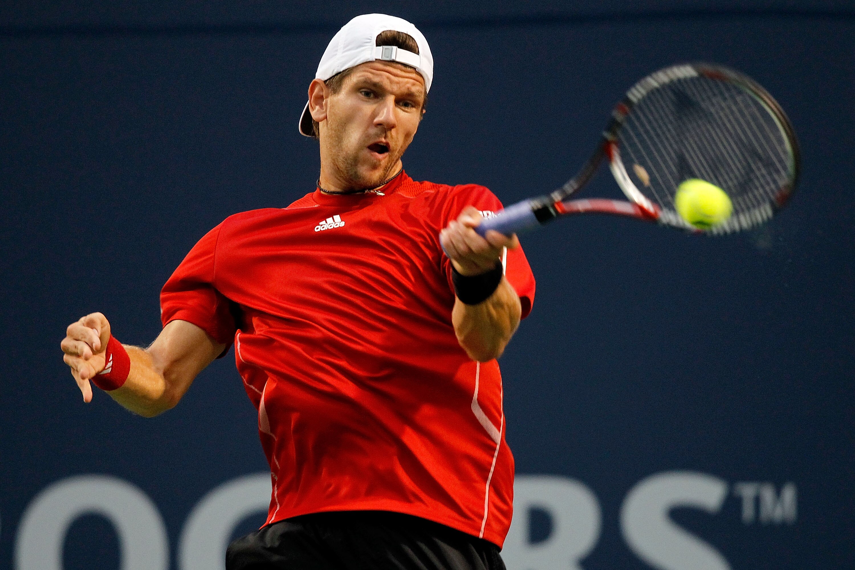 TORONTO, ON - AUGUST 09: Jurgen Melzer of Austria returns a shot to Peter Polansky of Canada during the Rogers Cup at the Rexall Centre on August 9, 2010 in Toronto, Canada.  (Photo by Matthew Stockman/Getty Images)