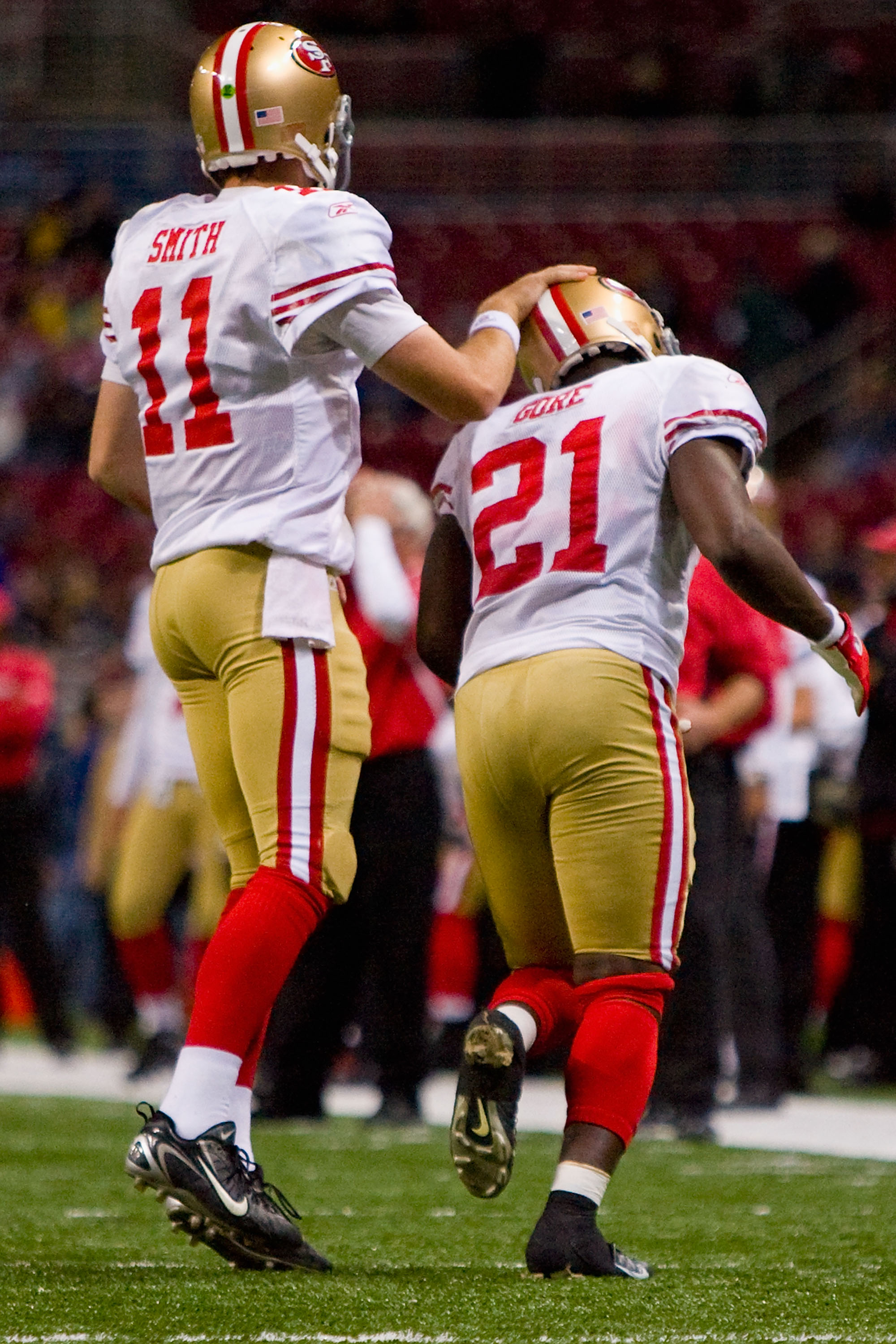 ST. LOUIS - JANUARY 3: Alex Smith #11 of the San Francisco 49ers congratulates teammate Frank Gore #21 after scoring a touchdown against the St. Louis Rams at the Edward Jones Dome on January 3, 2010 in St. Louis, Missouri.  The 49ers beat the Rams 28-6. 