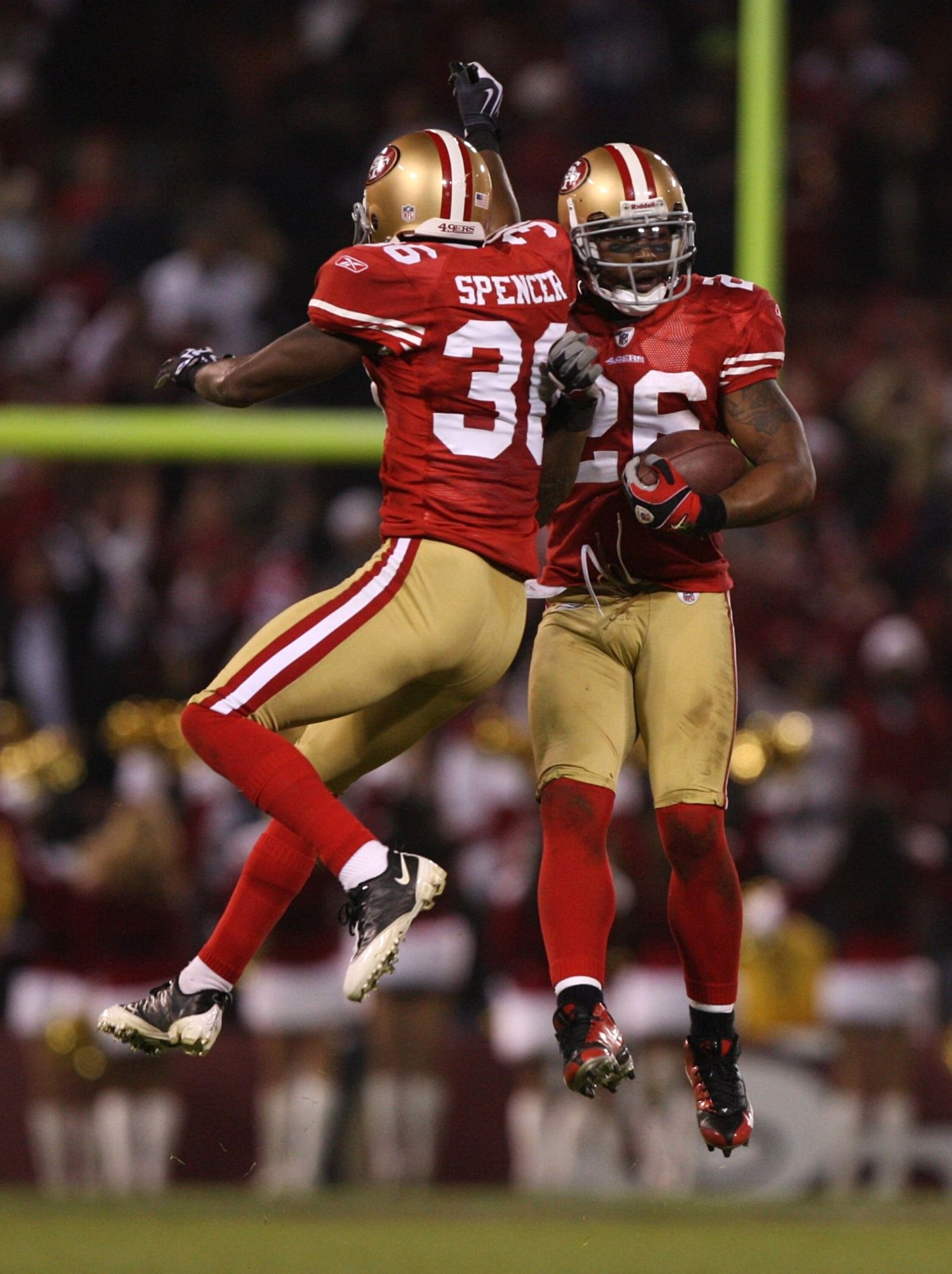 SAN FRANCISCO - DECEMBER 14:  Mark Roman #26 of the San Francisco 49ers celebrates with Shawntae Spencer #36 after Roman recovered a fumble by Anquan Boldin #81 of the Arizona Cardinals in the fourth quarter at Candlestick Park on December 14, 2009 in San
