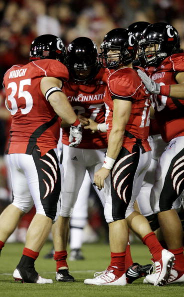 CINCINNATI - NOVEMBER 13:  Quarterback Zach Collaros #12 of the Cincinnati Bearcats congratulates kicker Jake Rogers #97 after his 38 yard field goal in the fourth quarter against the West Virginia Mountaineers at Nippert Stadium on November 13, 2009 in C