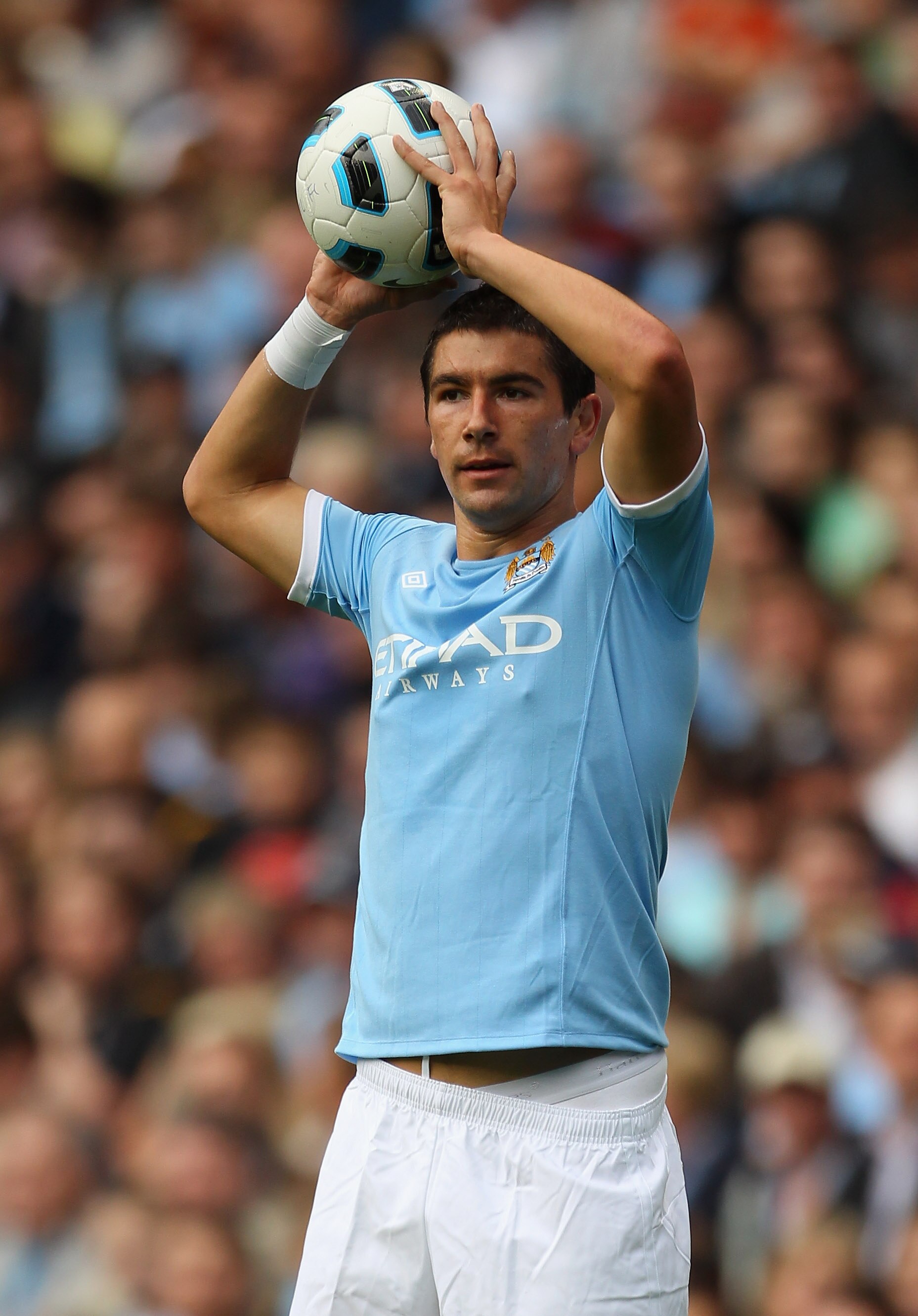 MANCHESTER, ENGLAND - AUGUST 07:  Aleksandar Kolarov of Manchester City takes a throw in during the pre-season friendly match between Manchester City and Valencia at the City of Manchester Stadium on August 7, 2010 in Manchester, England.  (Photo by Alex