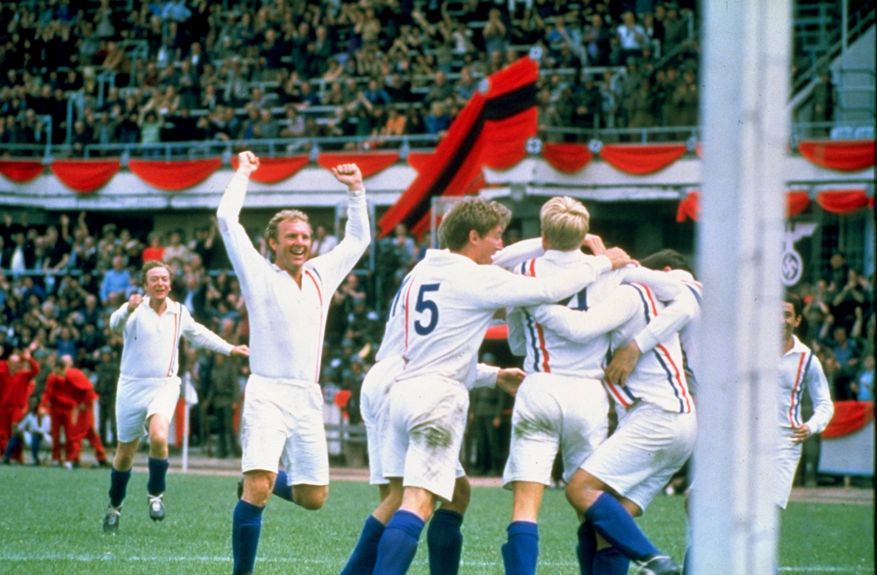 Undated:  Actor Michael Caine and England player Bobby Moore of the POW XI celebrate during a match against Germany for the film Escape to Victory.  \ Mandatory Credit: Allsport UK /Allsport