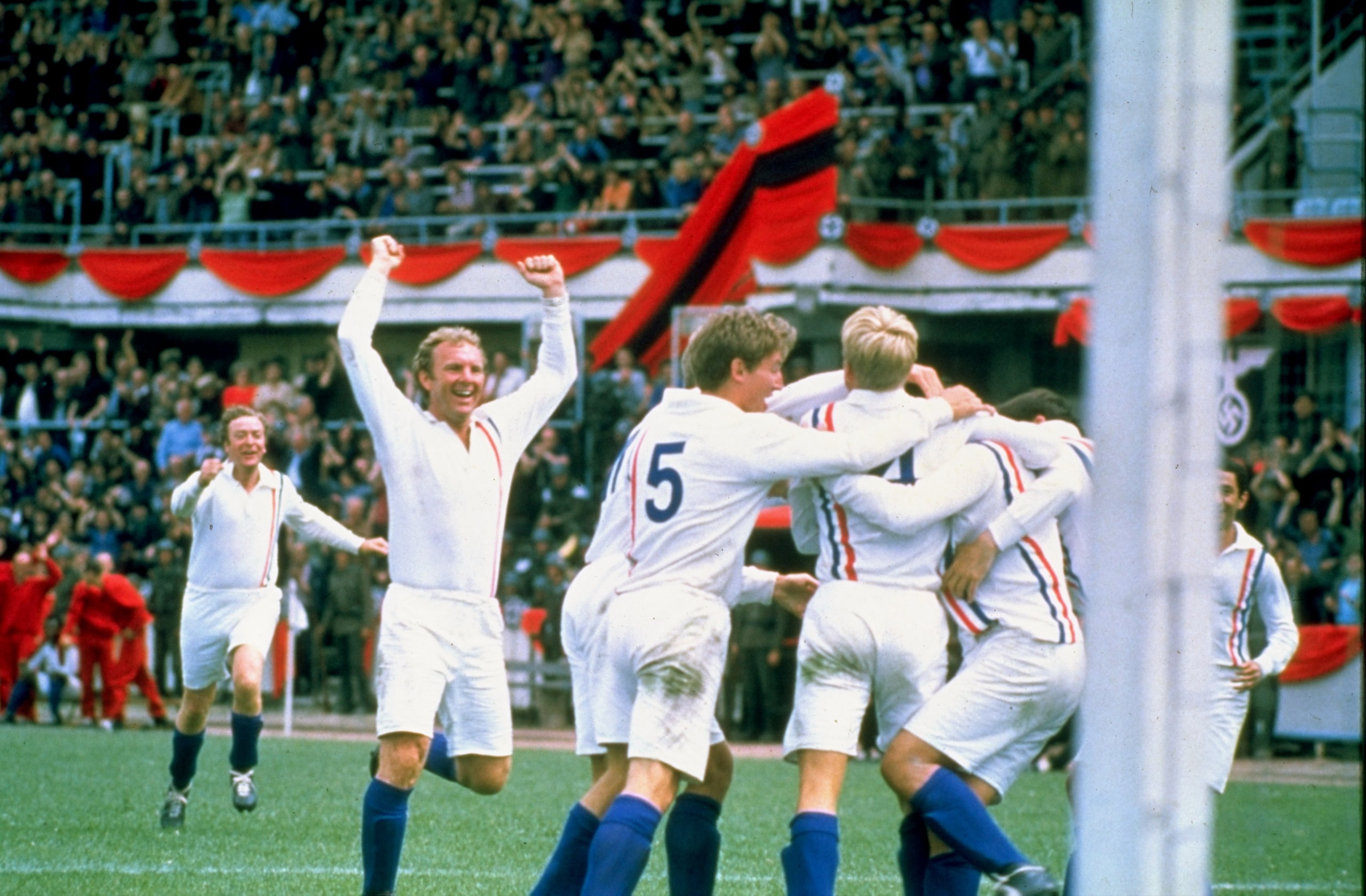 Undated:  Actor Michael Caine and England player Bobby Moore of the POW XI celebrate during a match against Germany for the film Escape to Victory.  \ Mandatory Credit: Allsport UK /Allsport