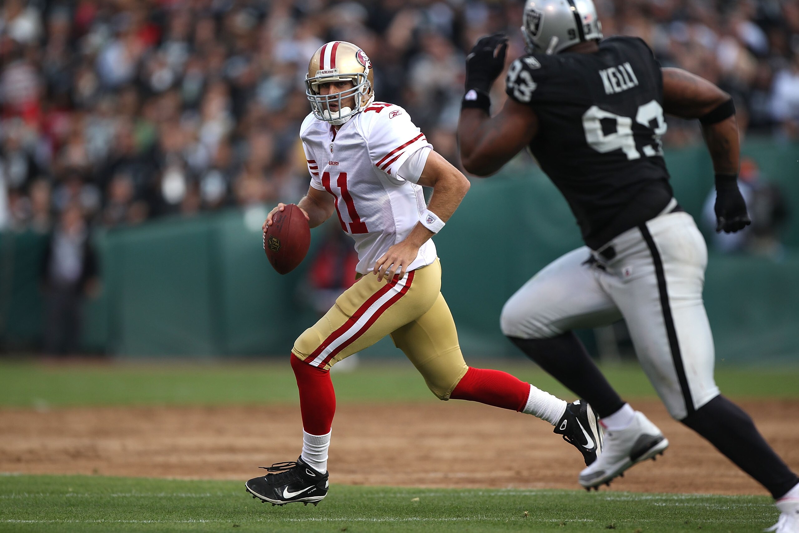 OAKLAND, CA - AUGUST 28:  Alex Smith #11 of the San Francisco 49ers passes against Tommy Kelly #93 of the Oakland Raiders during an NFL preseason game at Oakland-Alameda County Coliseum on August 28, 2010 in Oakland, California.  (Photo by Jed Jacobsohn/G