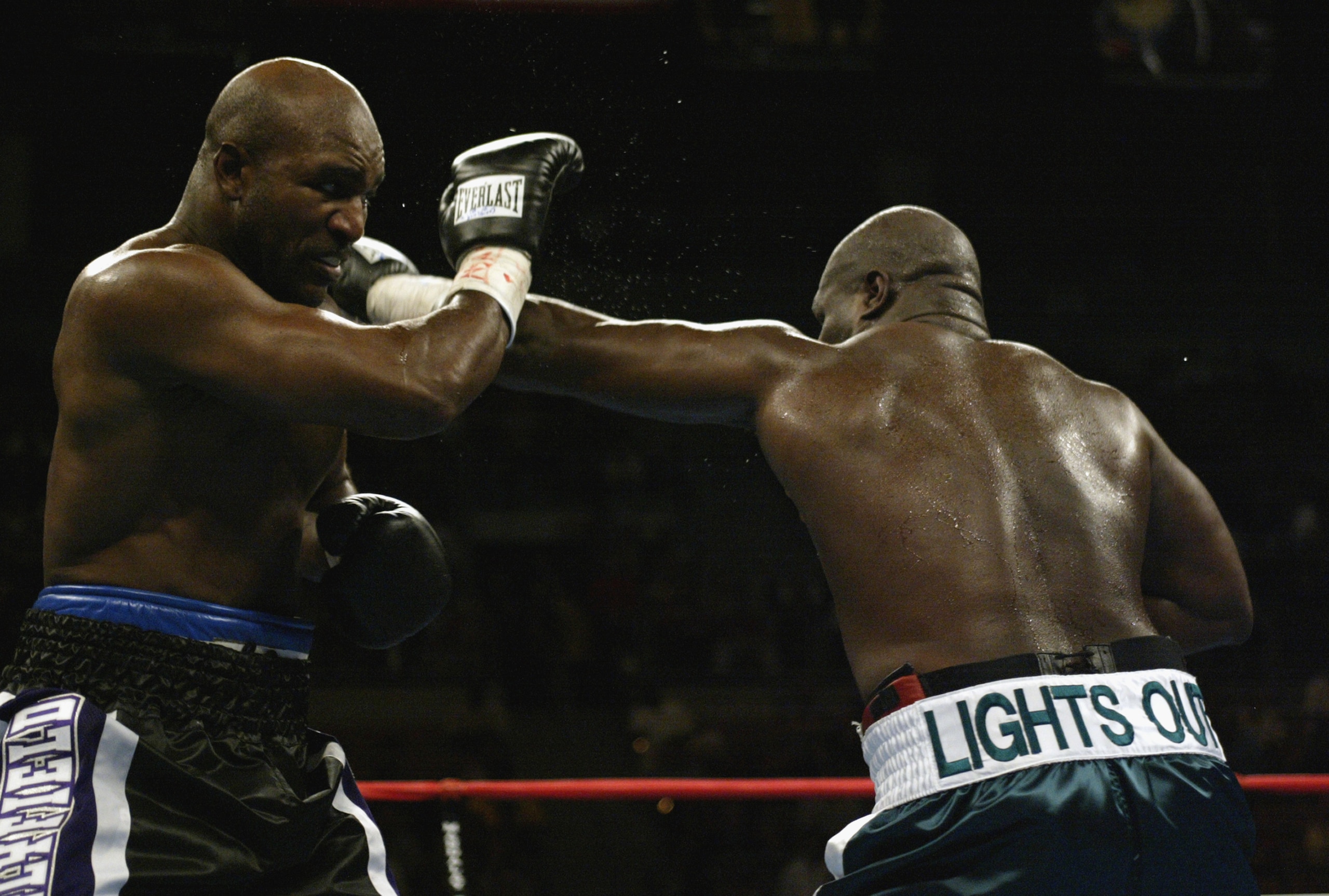 LAS VEGAS - OCTOBER 4:  Evander Holyfield deflects the left-hand punch of James Toney in a heavyweight fight at the Mandalay Bay Casino on October 4, 2003 in Las Vegas, Nevada.  Toney defeated Holyfield by TKO in the ninth round.  (Photo by Jed Jacobsohn/