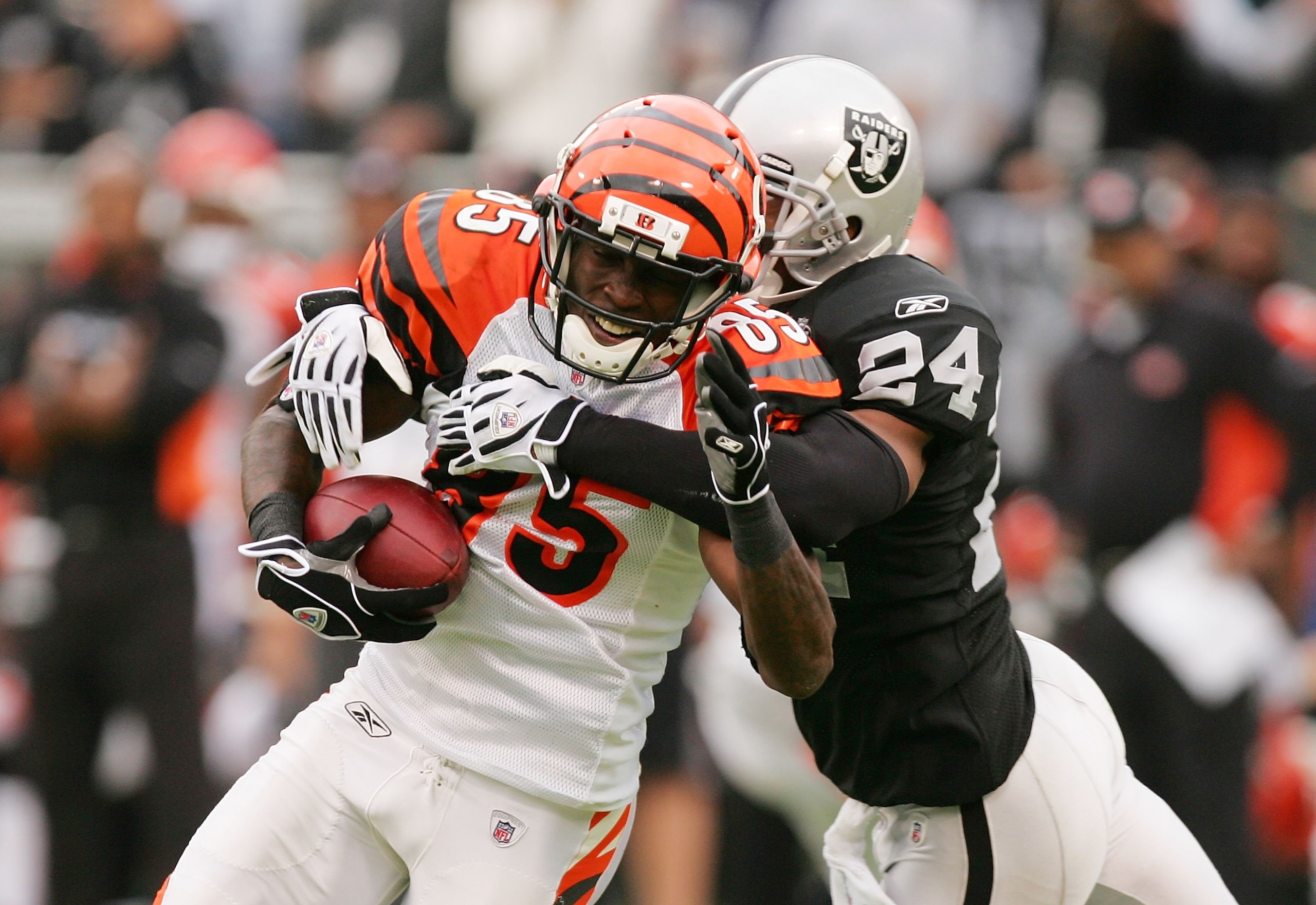 OAKLAND, CA - NOVEMBER 22:  Chad Ochocinco #85 of the Cincinnati Bengals is tackled by Michael Huff #24 of the Oakland Raiders at Oakland-Alameda County Coliseum on November 22, 2009 in Oakland, California.  (Photo by Ezra Shaw/Getty Images)