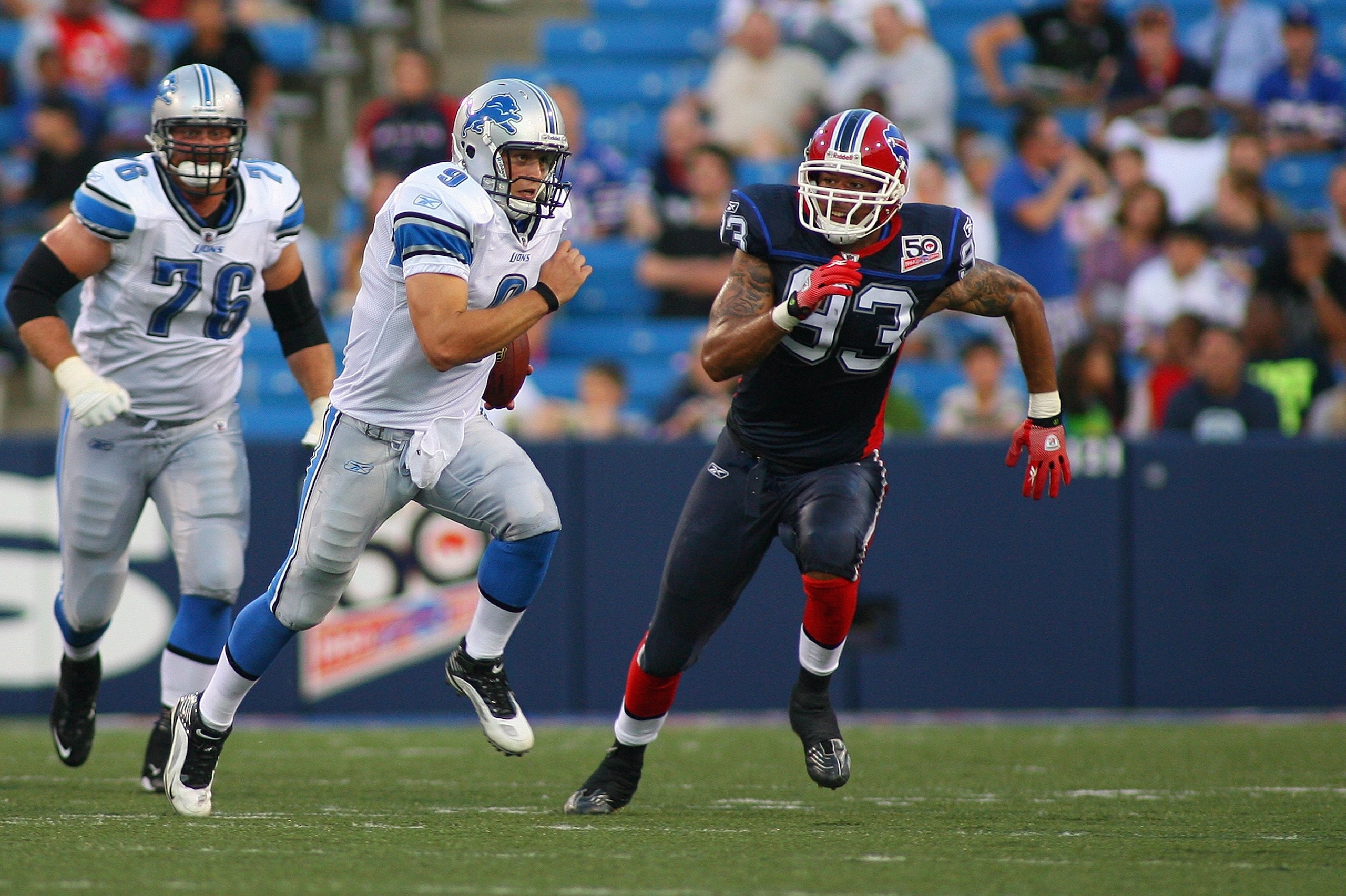 ORCHARD PARK, NY - SEPTEMBER 3:  Matthew Stafford #9 of the Detroit Lions scrambles against Chris Ellis #93 of the Buffalo Bills during the preseason game at Ralph Wilson Stadium on September 3, 2009 in Orchard Park, New York. (Photo by Rick Stewart/Getty