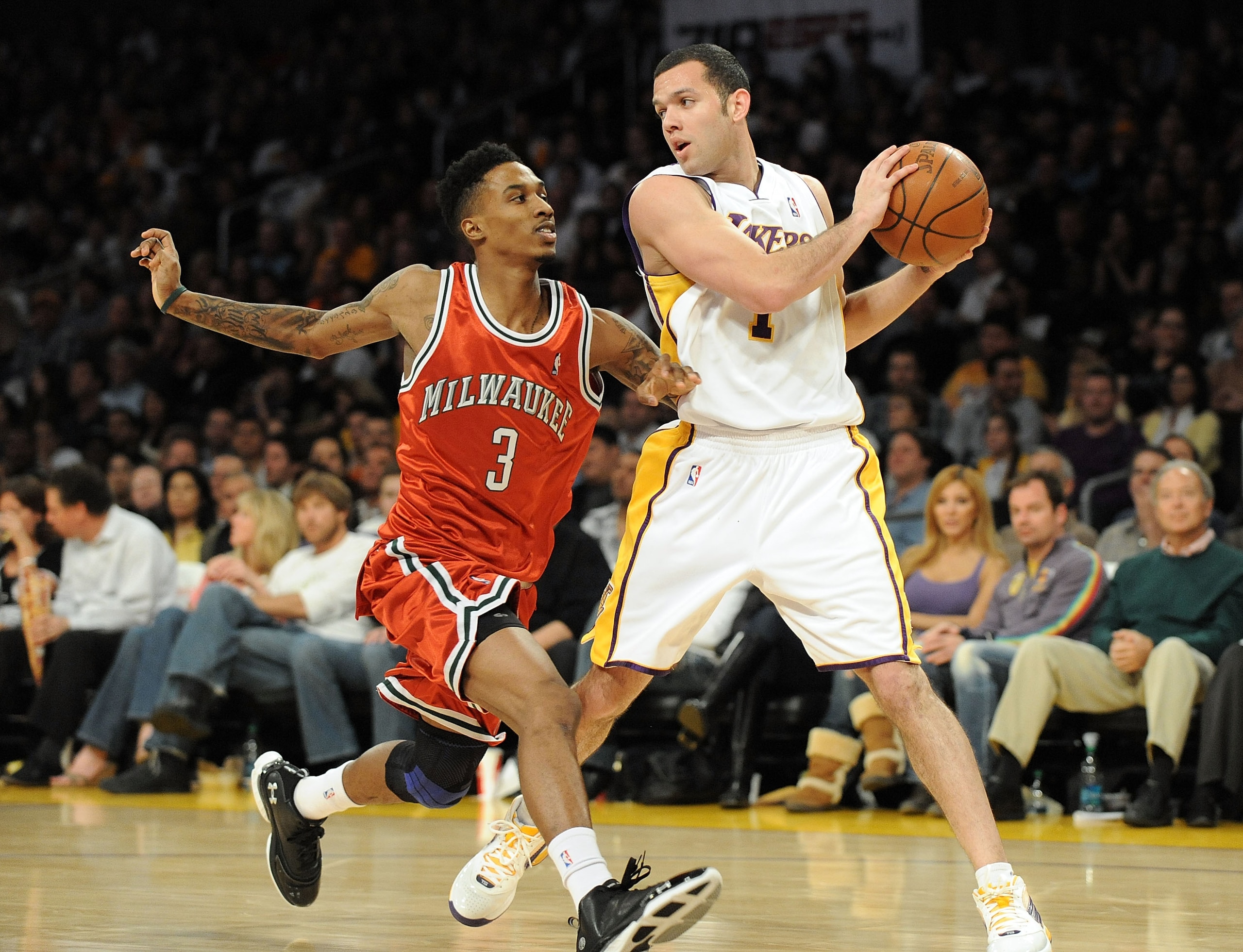 LOS ANGELES, CA - JANUARY 10:  Jordan Farmar #1 of Los Angeles Lakers keeps the ball away from Brandon Jennings #3 of the Milwaukee Bucks during the game at Staples Center on January 10, 2010 in Los Angeles, California.  NOTE TO USER: User expressly ackno