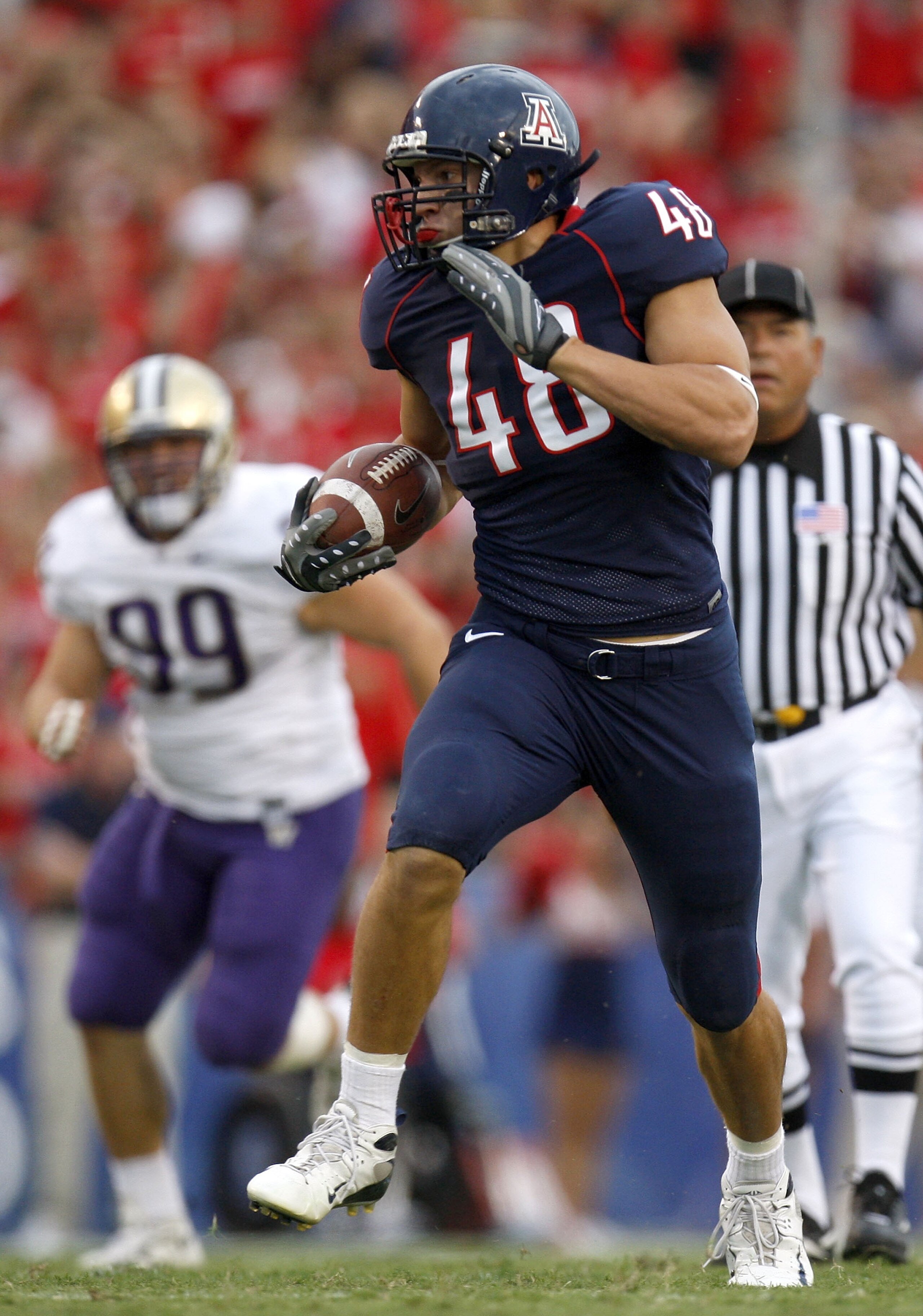 TUCSON, AZ - OCTOBER 04:  Rob Gronkowski #48 of the Arizona Wildcats runs for a first quarter touchdown in front of Cameron Elisara #99 of the Washington Huskies during a first quarter run on October 4, 2008 at Arizona Stadium in Tucson, Arizona.  (Photo