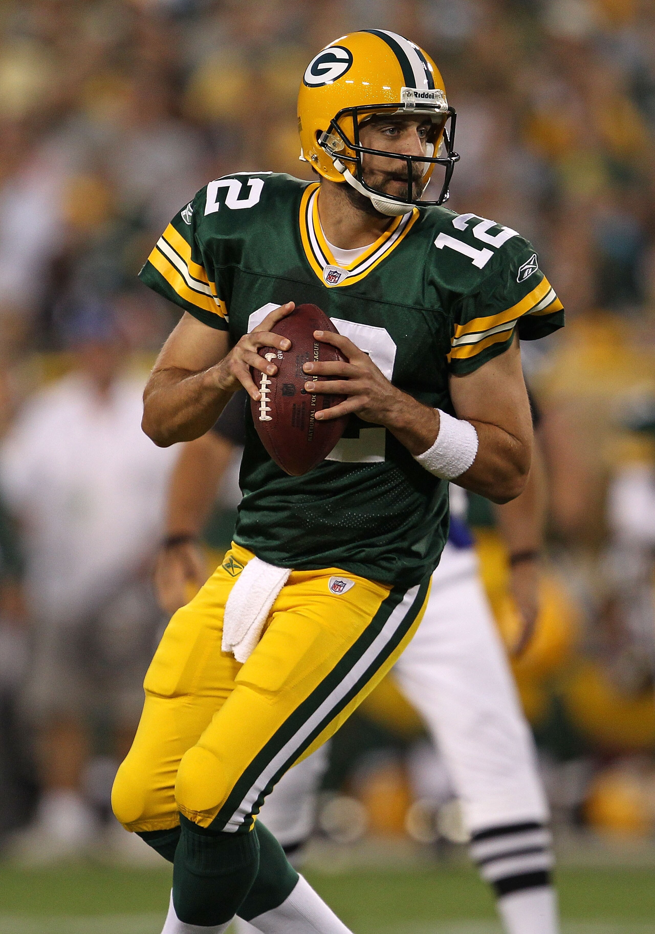 GREEN BAY, WI - AUGUST 26: Aaron Rodgers #12 of the Green Bay Packers looks for a receiver against the Indianapolis Colts during a preseason game at Lambeau Field on August 26, 2010 in Green Bay, Wisconsin. The Packers defeated the Colts 59-24.  (Photo by