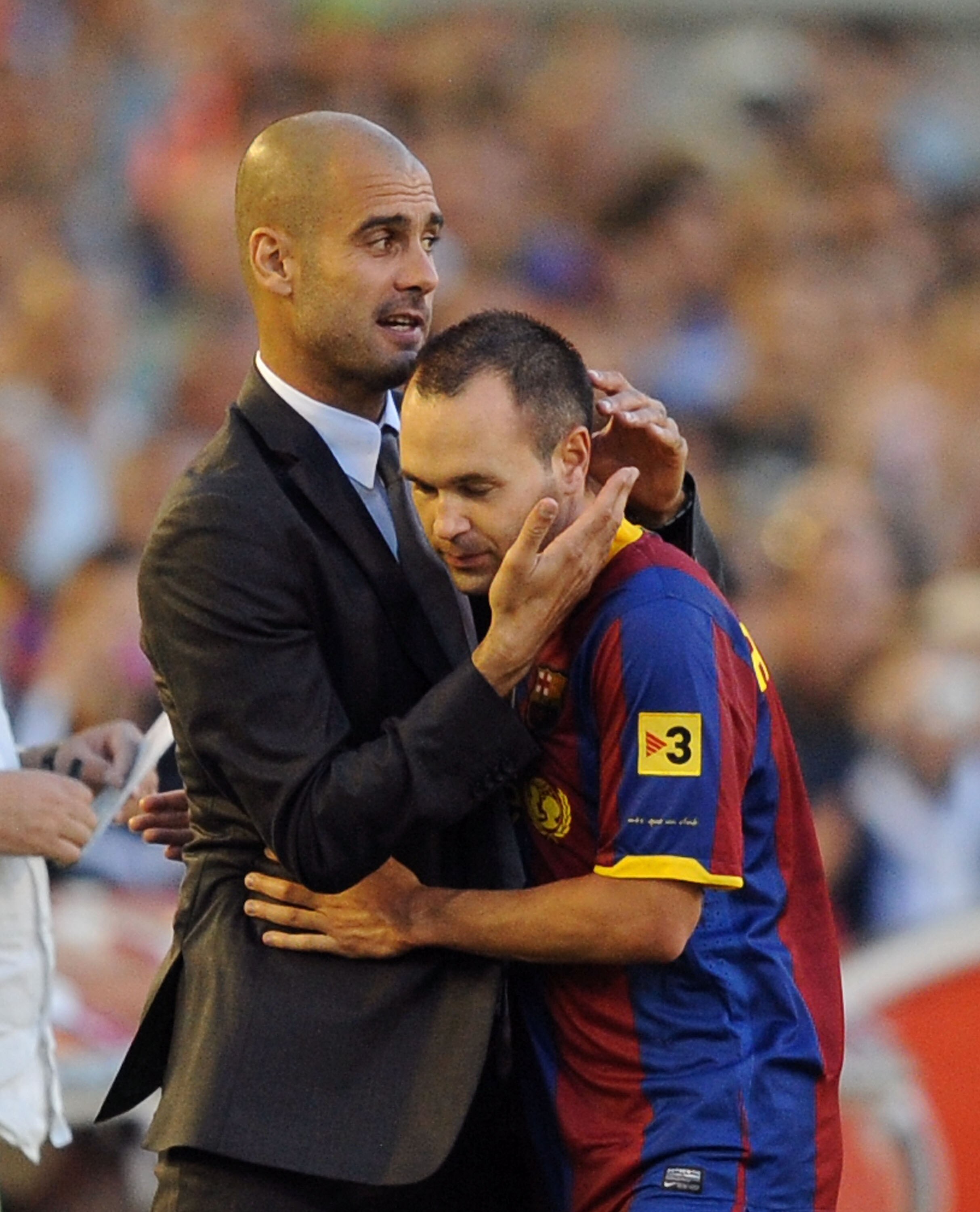 SANTANDER, SPAIN - AUGUST 29:  Barcelona manager Josep Guardiola (L) embraces Andres Iniesta after he was substituted during the La Liga match between Racing Santander and Barcelona at El Sardinero stadium on August 29, 2010 in Santander, Spain.  (Photo b
