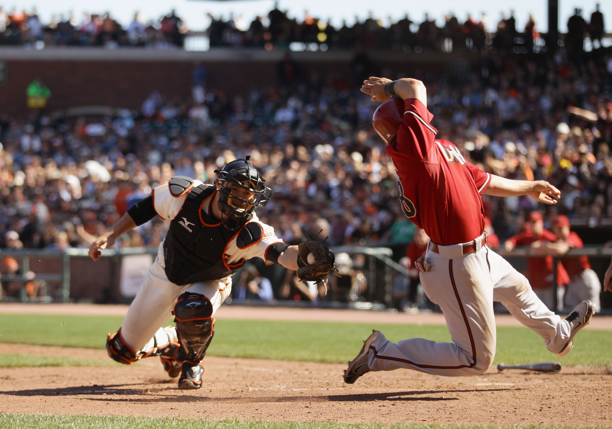 SAN FRANCISCO - AUGUST 29:  Gerardo Parra #18 of the Arizona Diamondbacks safely gets around the tag of Eli Whiteside #22 of the San Francisco Giants in the eighth inning at AT&T Park on August 29, 2010 in San Francisco, California. Parra slide past home