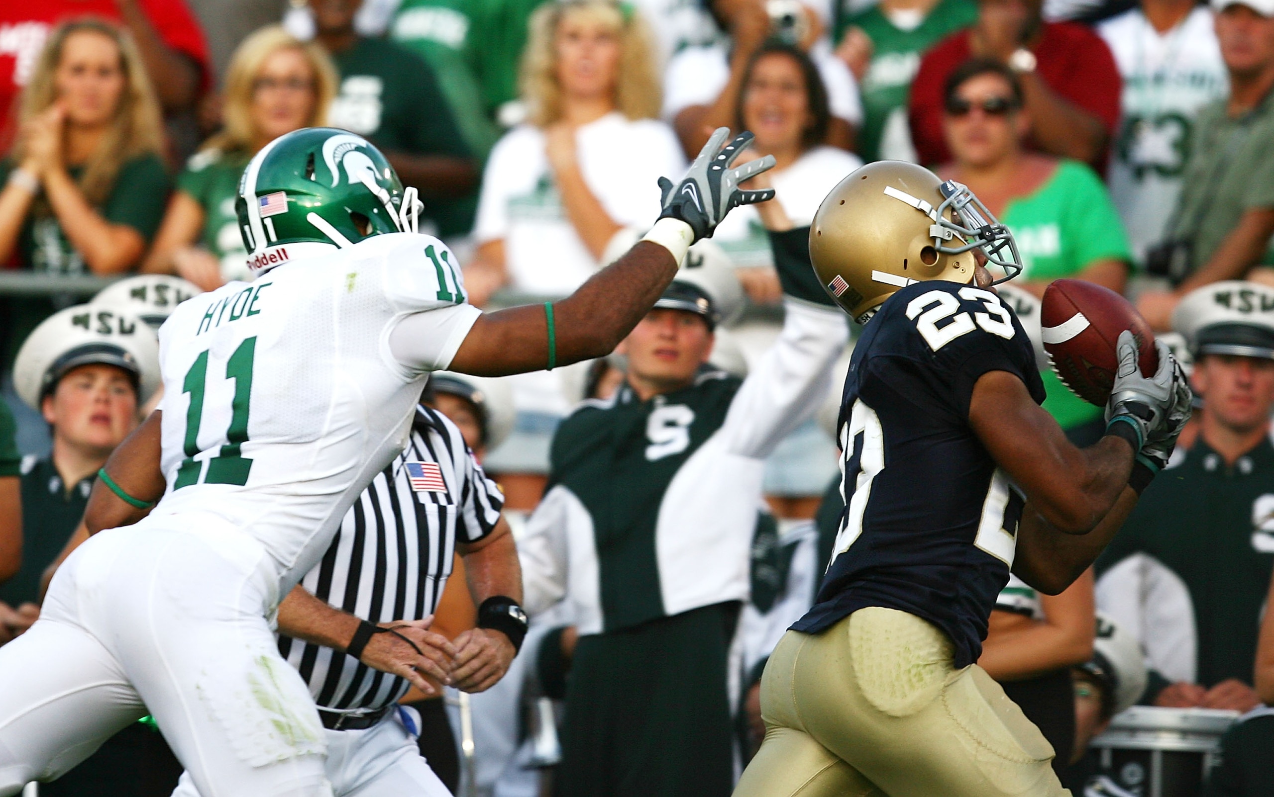 SOUTH BEND, IN - SETPEMBER 19: Golden Tate #23 of the Notre Dame Fighting Irish catches the game- winning touchdown pass over Marcus Hyde #11 of the Michigan State Spartans on September 19, 2009 at Notre Dame Stadium in South Bend, Indiana. Notre Dame def