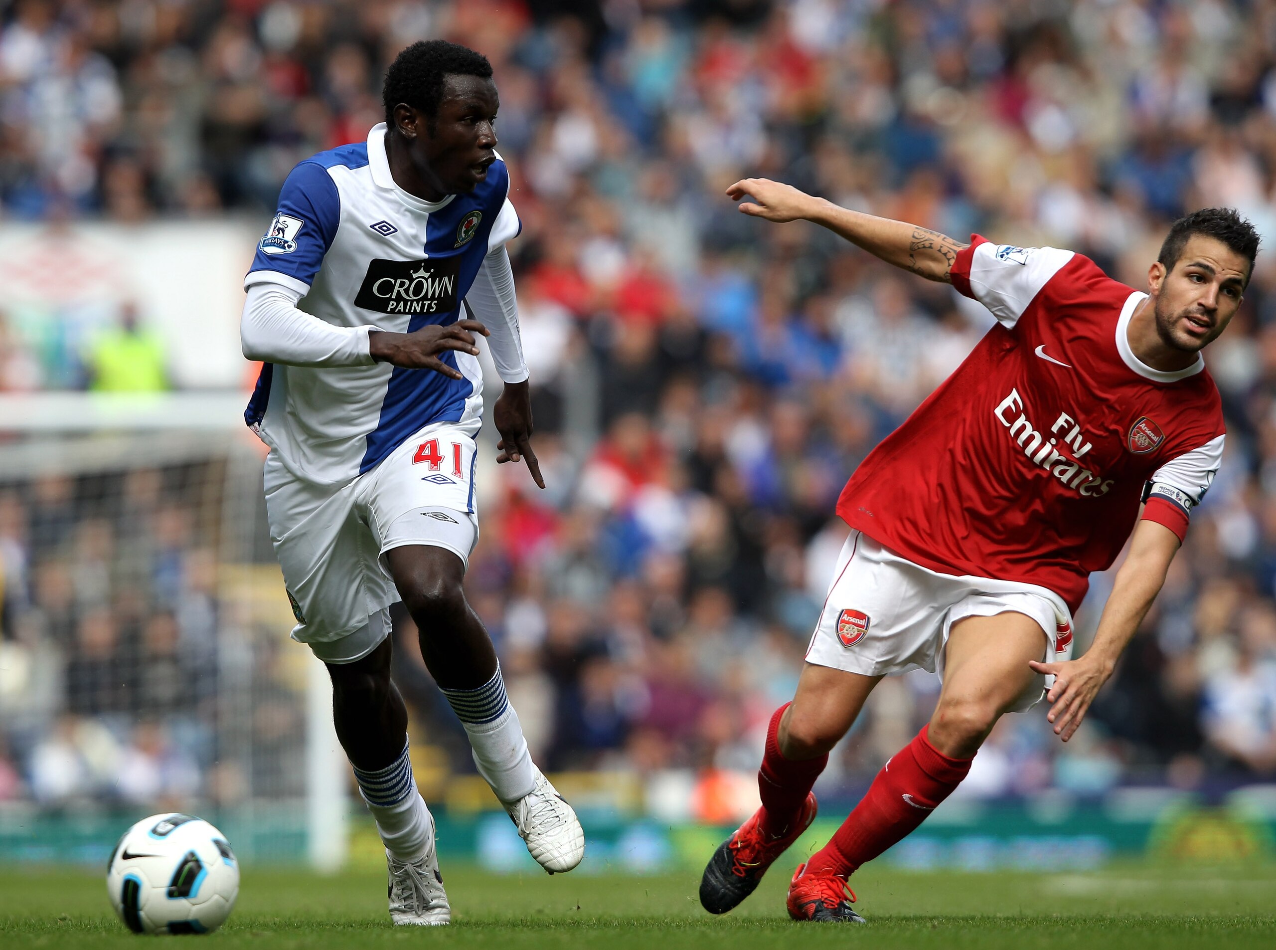 BLACKBURN, ENGLAND - AUGUST 28:  Mame Biram Diouf of Blackburn Rovers goes past Cesc Fabregas of Arsenal during the Barclays Premier League match between Blackburn Rovers and Arsenal at Ewood Park on August 28, 2010 in Blackburn, England.  (Photo by Clive