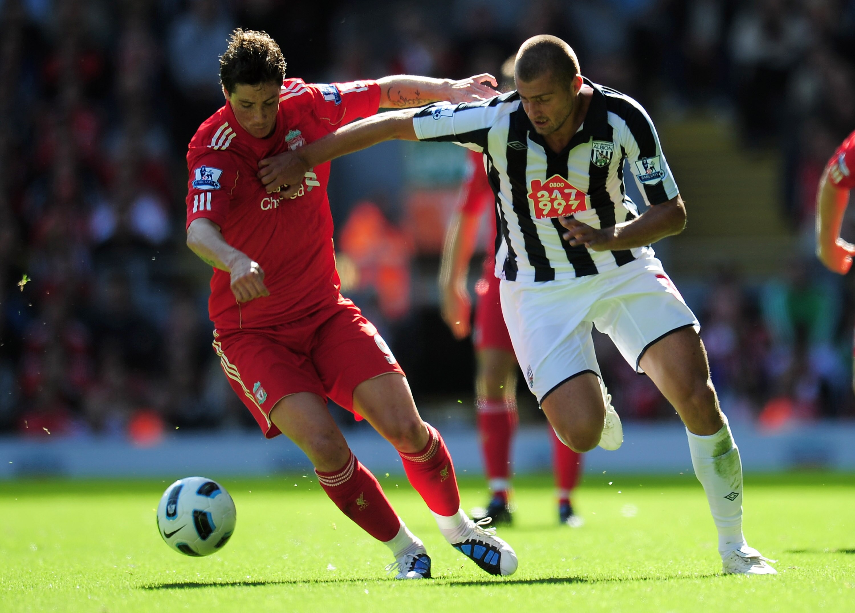 LIVERPOOL, ENGLAND - AUGUST 29:  Gabriel Tamas of West Bromwich Albion battles for the ball with Fernando Torres of Liverpool during the Barclays Premier League match between Liverpool and West Bromwich Albion at Anfield on August 29, 2010 in Liverpool, E