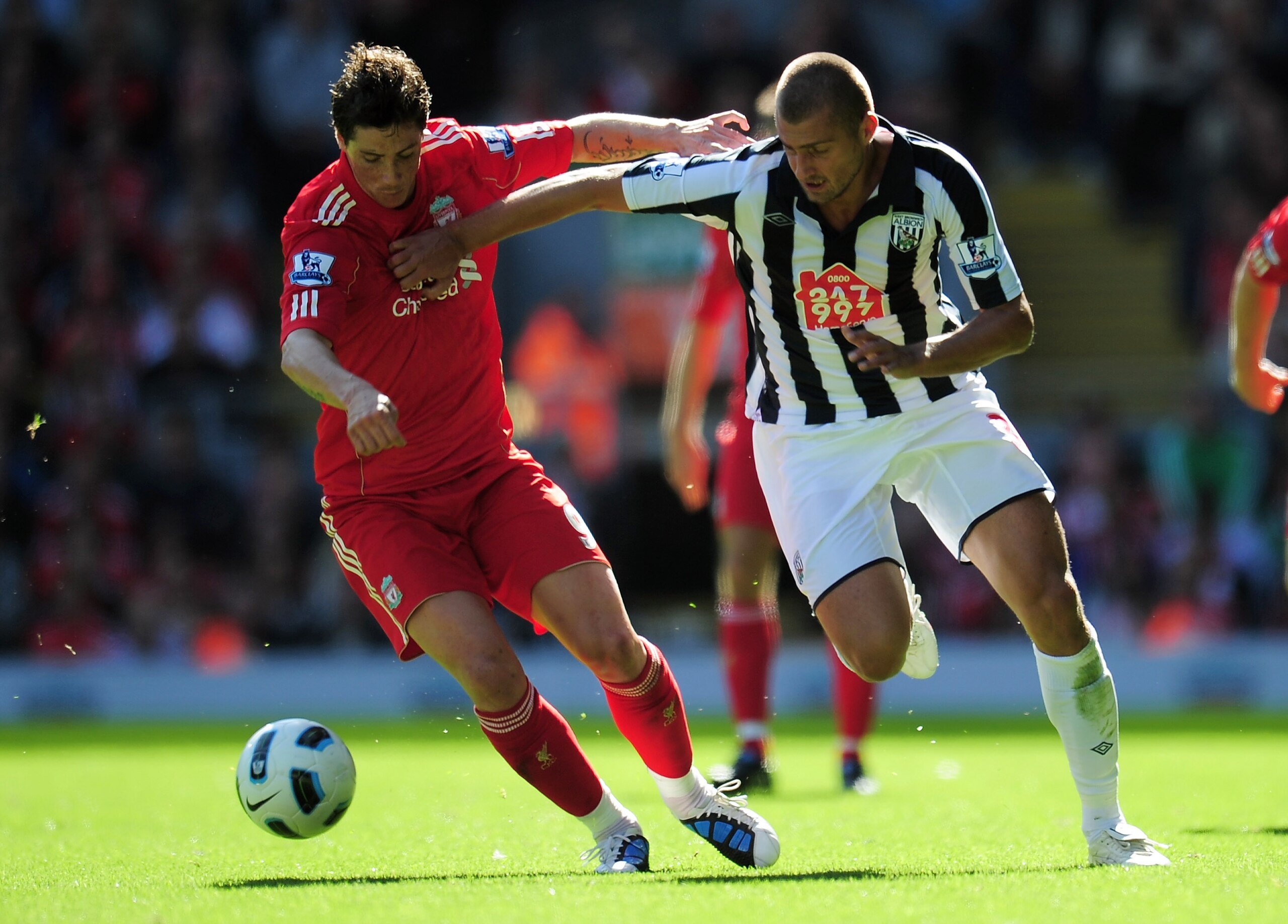 LIVERPOOL, ENGLAND - AUGUST 29:  Gabriel Tamas of West Bromwich Albion battles for the ball with Fernando Torres of Liverpool during the Barclays Premier League match between Liverpool and West Bromwich Albion at Anfield on August 29, 2010 in Liverpool, E