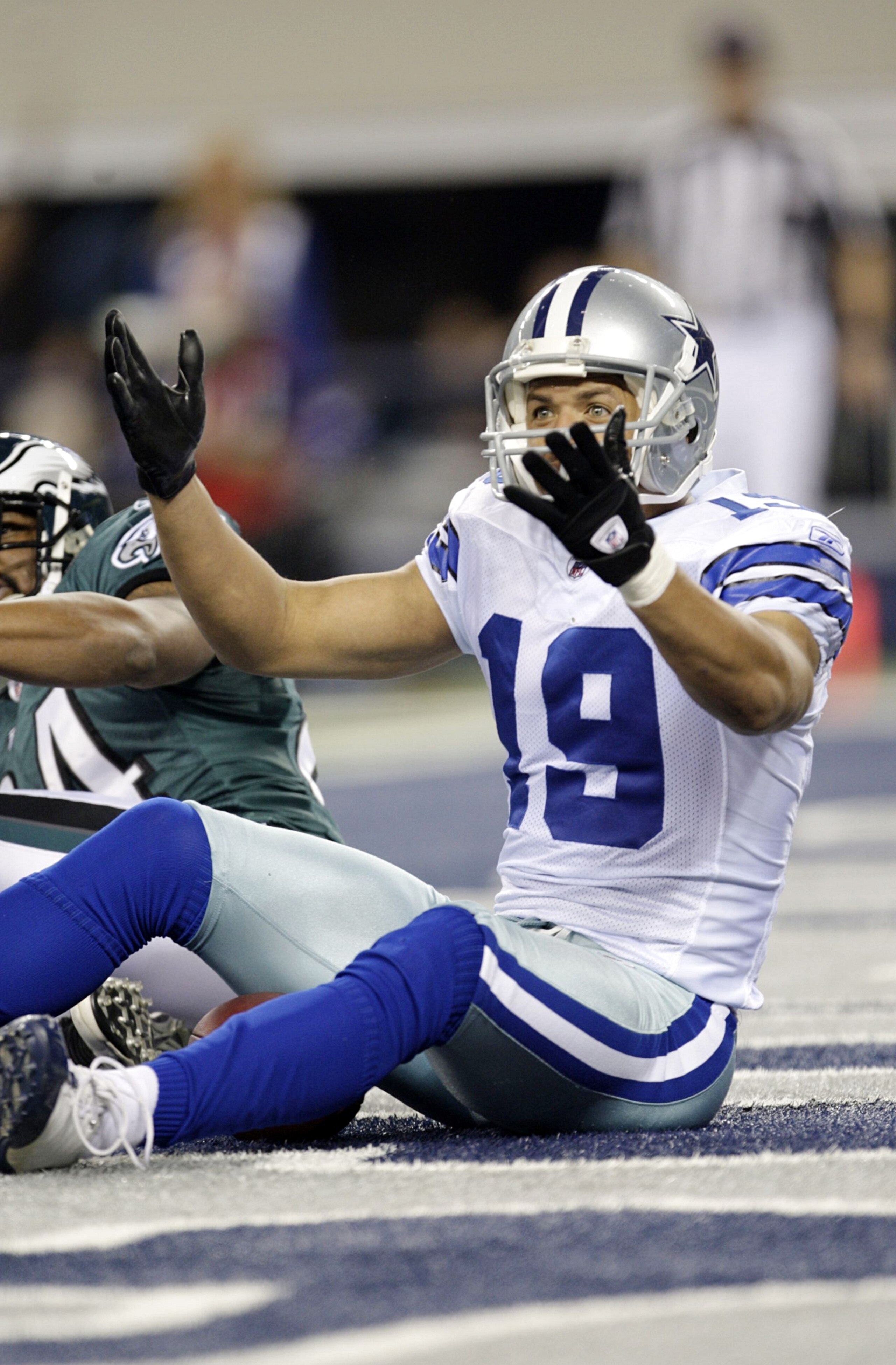ARLINGTON, TX - JANUARY 9:  Miles Austin #19 of the Dallas Cowboys wants a passing interference penalty called in the endzone on Sheldon Brown #24 of the Philadelphia Eagles in the second quarter during the 2010 NFC wild-card playoff game at Cowboys Stadi