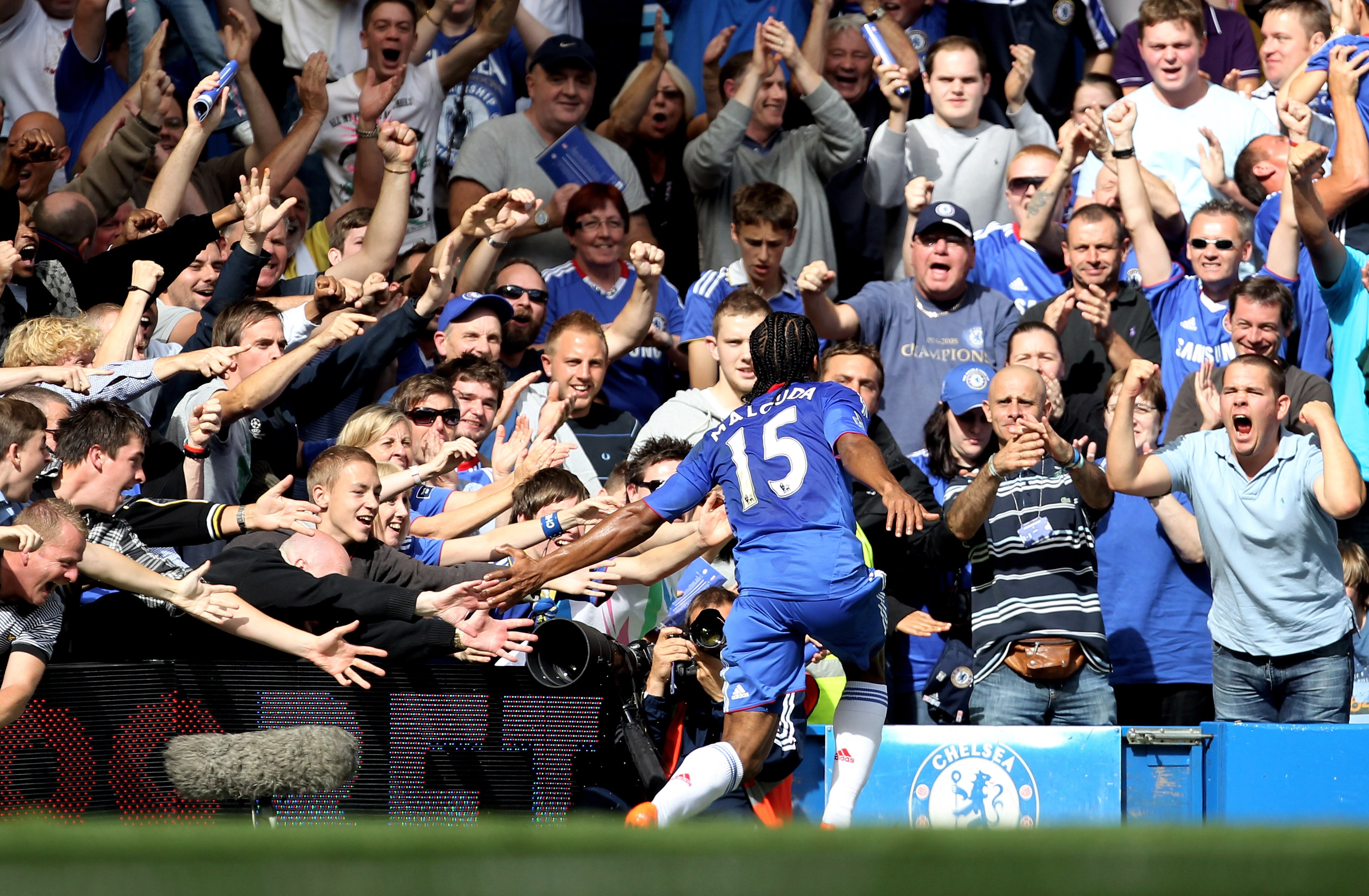 LONDON, ENGLAND - AUGUST 28:  Florent Malouda of Chelsea celebrates with the fans after scoring the opening goal during the Barclays Premier League match between Chelsea and Stoke City at Stamford Bridge on August 28, 2010 in London, England.  (Photo by B