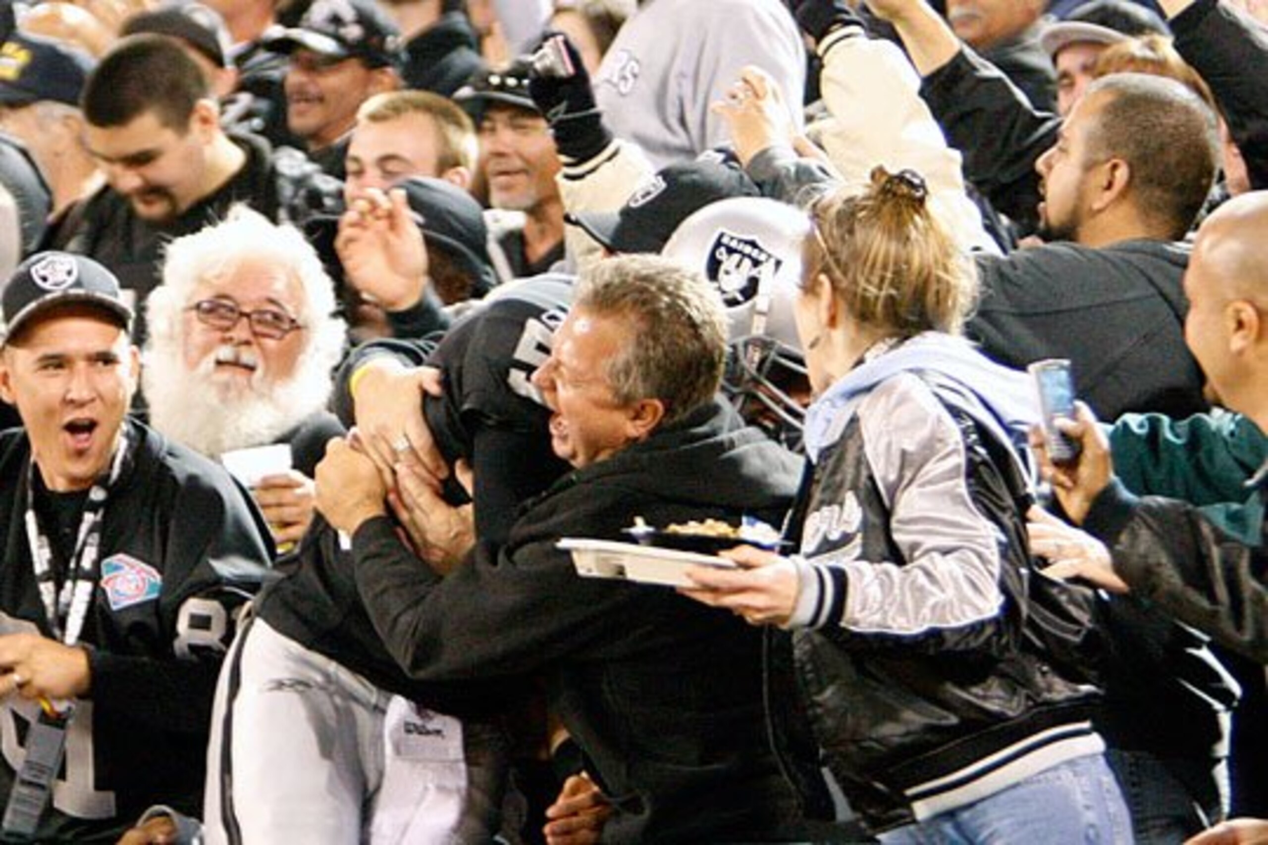 Gradkowski gets some love from the fans in "The Black Hole" after a touchdown pass to Miller.
