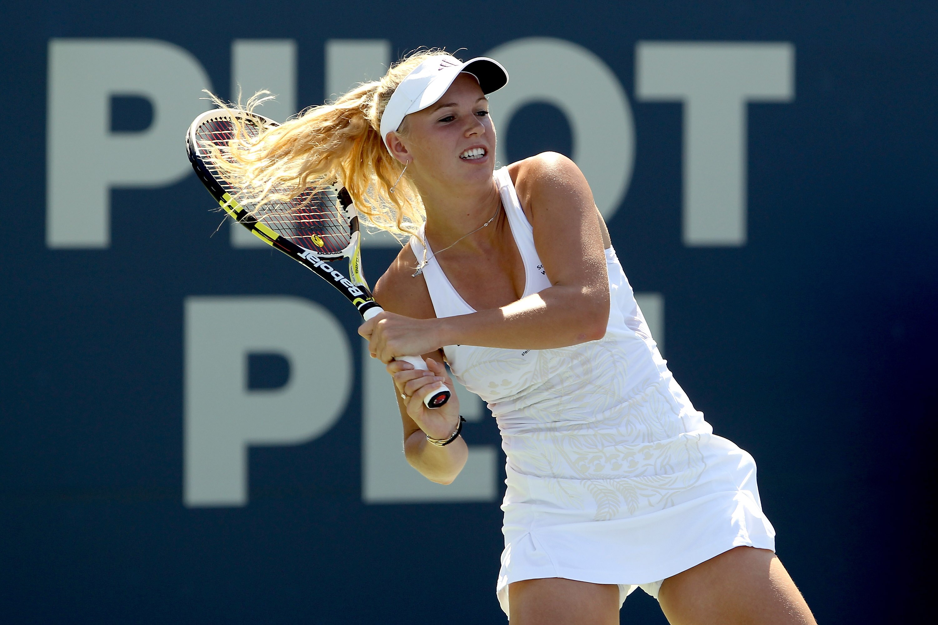 NEW HAVEN, CT - AUGUST 28:  Top seed Caroline Wozniacki of Denmark returns a shot to Nadia Petrova of Russia during the final of the Pilot Pen tennis tournament at the Connecticut Tennis Center on August 28, 2010 in New Haven, Connecticut. Wozniacki beat 