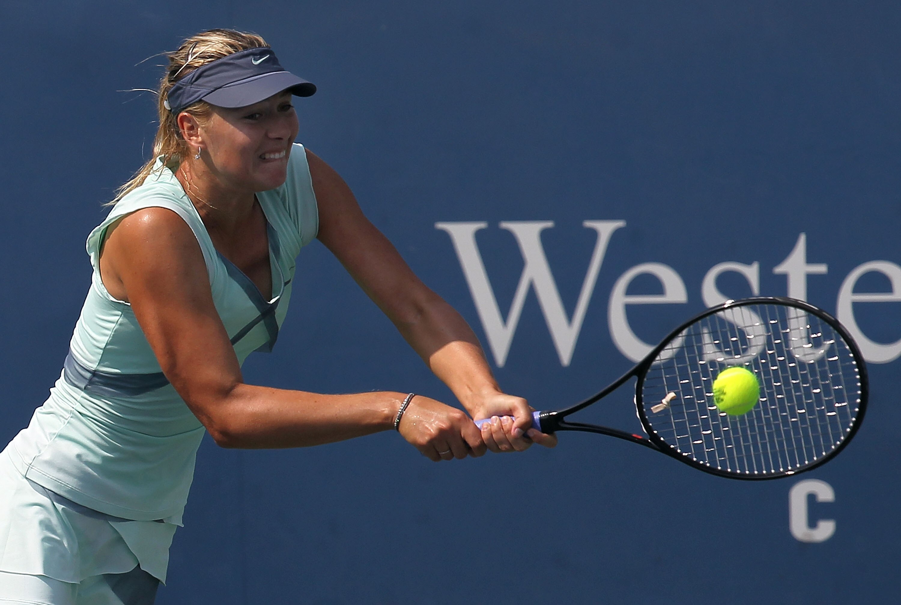 CINCINNATI - AUGUST 15:  Maria Sharapova hits a backhand return during her singles final match against Kim Clijsters of Belgium on day seven of the Western & Southern Financial Group Women's Open on August 15, 2010 at the Lindner Family Tennis Center in C
