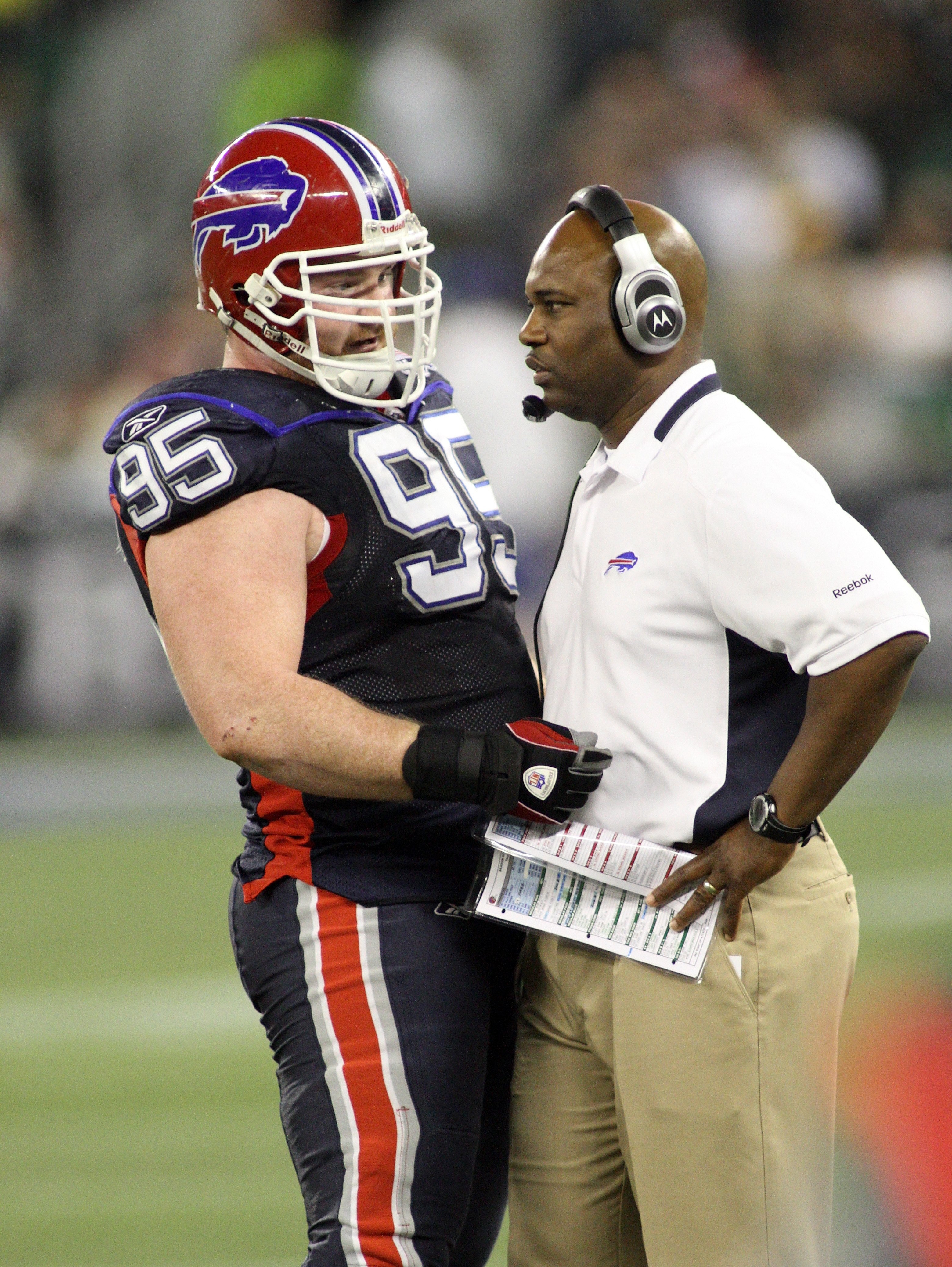TORONTO - DECEMBER 3:  Kyle Williams #95 and Head Coach Perry Fewell of the Buffalo Bills confer on the side line during their NFL game against the New York Jets on December 3, 2009  at Rogers Centre in Toronto, Ontario, Canada. The Jets defeated the Bill