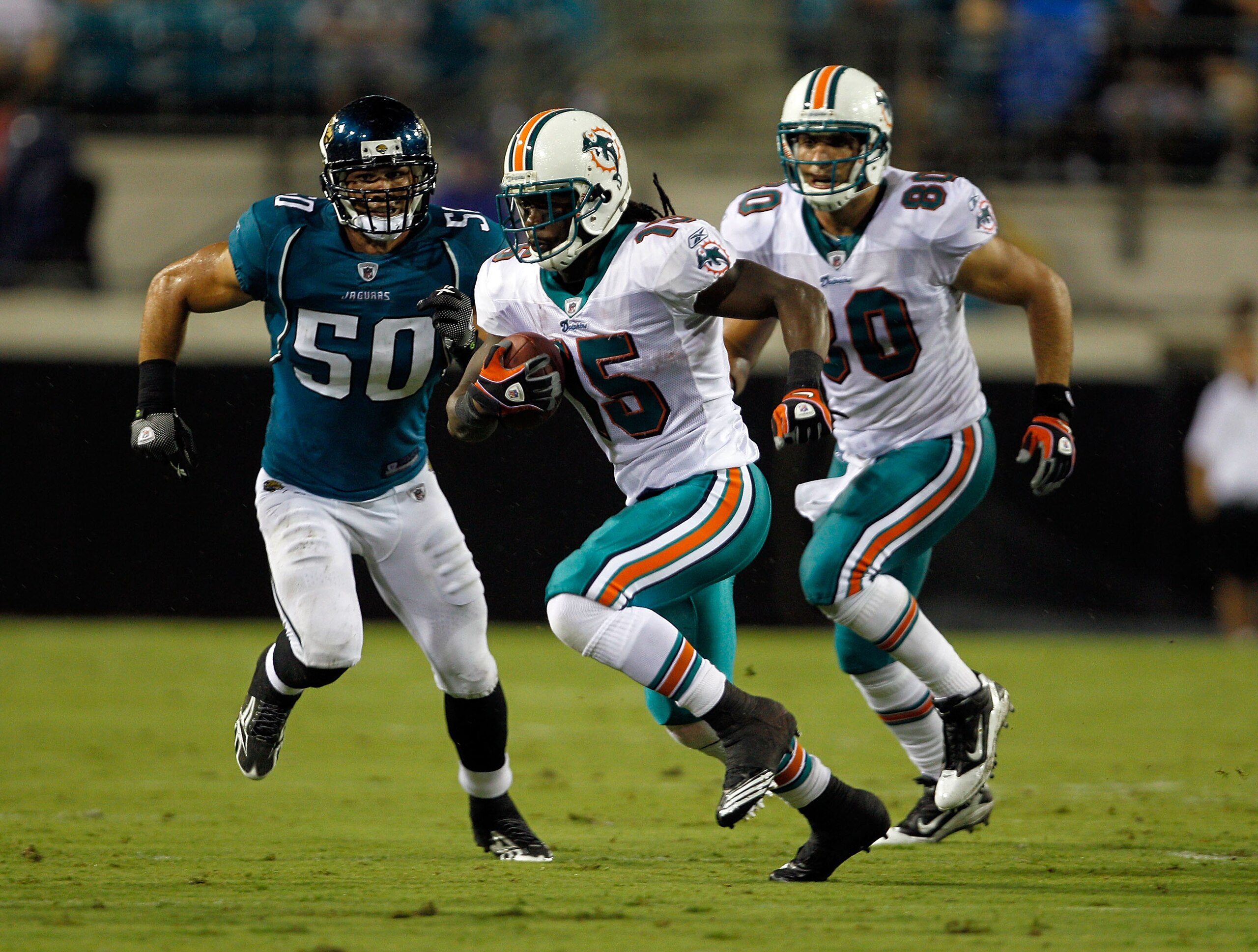 JACKSONVILLE, FL - AUGUST 21:  Russell Allen #50 of the Jacksonville Jaguars attempts to tackle Davone Bess #15 of the Miami Dolphins during the preseason game at EverBank Field on August 21, 2010 in Jacksonville, Florida.  (Photo by Sam Greenwood/Getty I