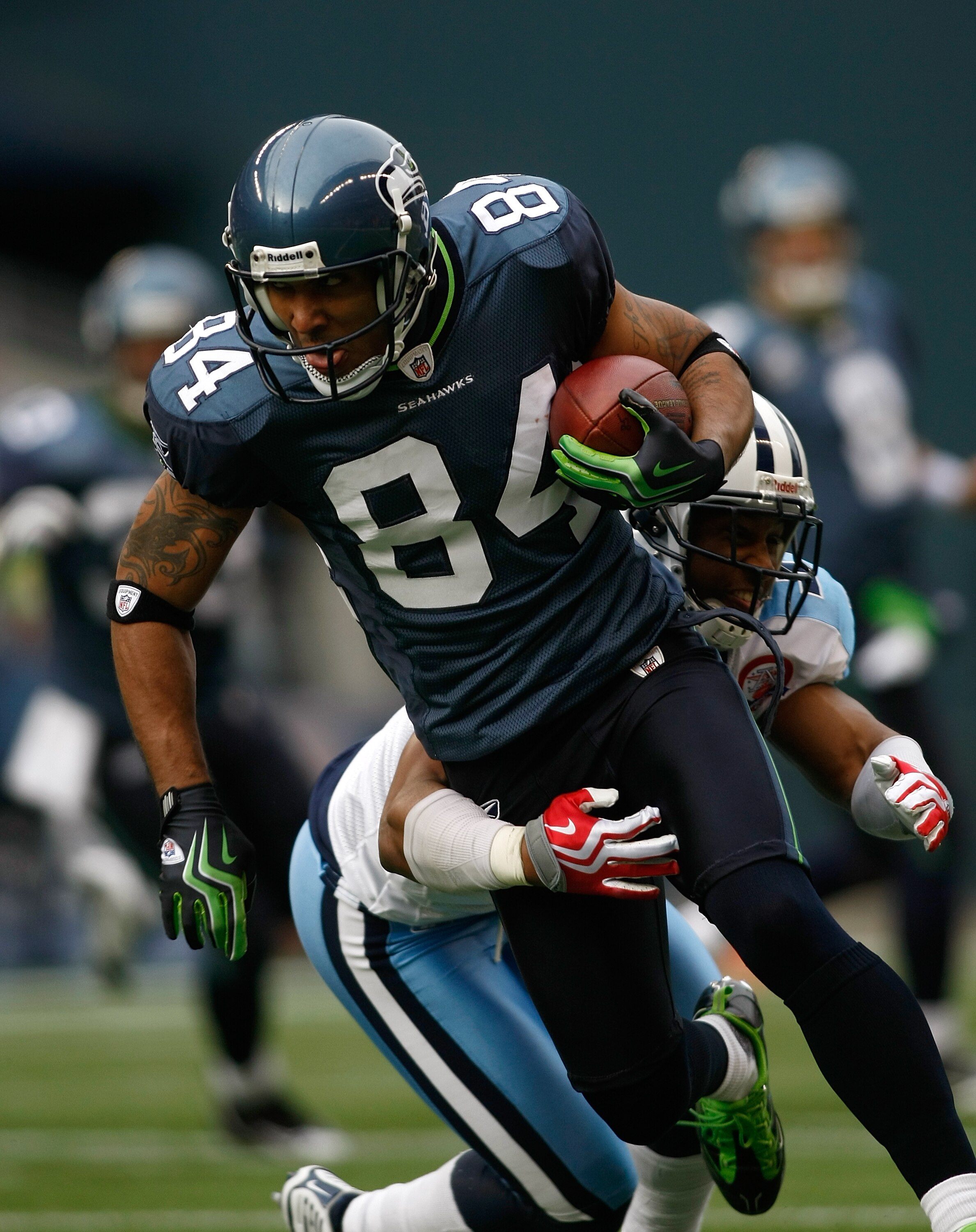 SEATTLE , WA - JANUARY 03:  T.J. Houshmandzadeh #84 of the Seattle Seahawks runs after making a catch against Rod Hood #37 of the Tennessee Titans at Qwest Field on January 3, 2010 in Seattle, Washington.  (Photo by Jonathan Ferrey/Getty Images)