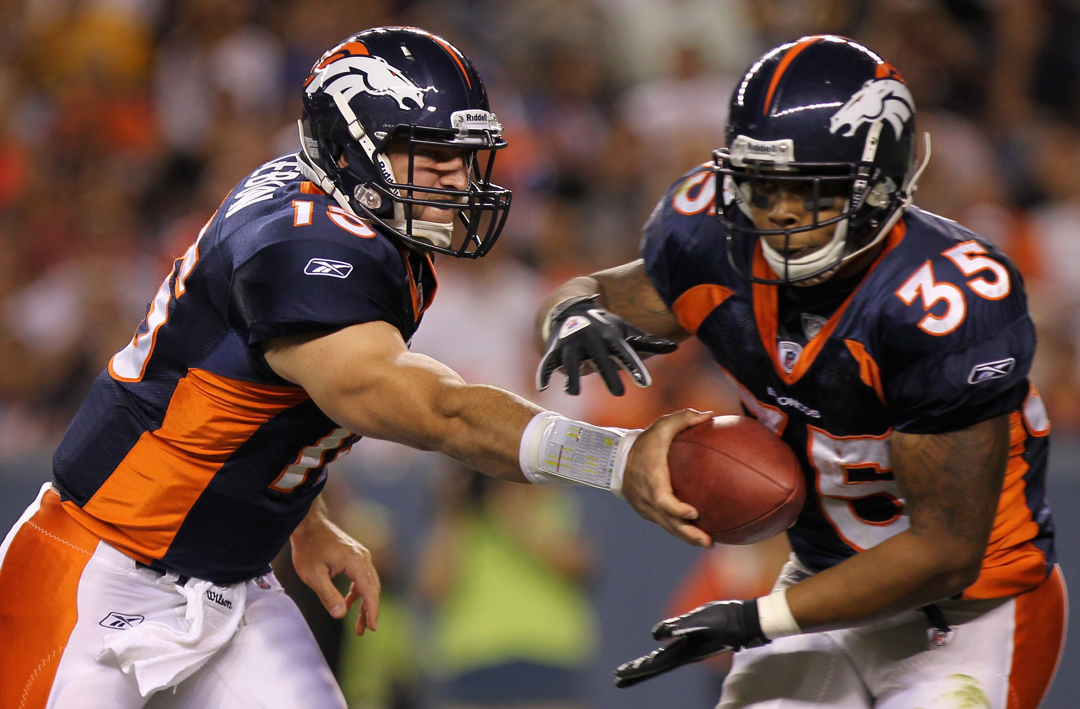 DENVER - AUGUST 29:  Quarterback Tim Tebow #15 of the Denver Broncos hands the ball off to running back Lance Ball #35 against the Pittsburgh Steelers during preseason NFL action at INVESCO Field at Mile High on August 29, 2010 in Denver, Colorado.  (Phot