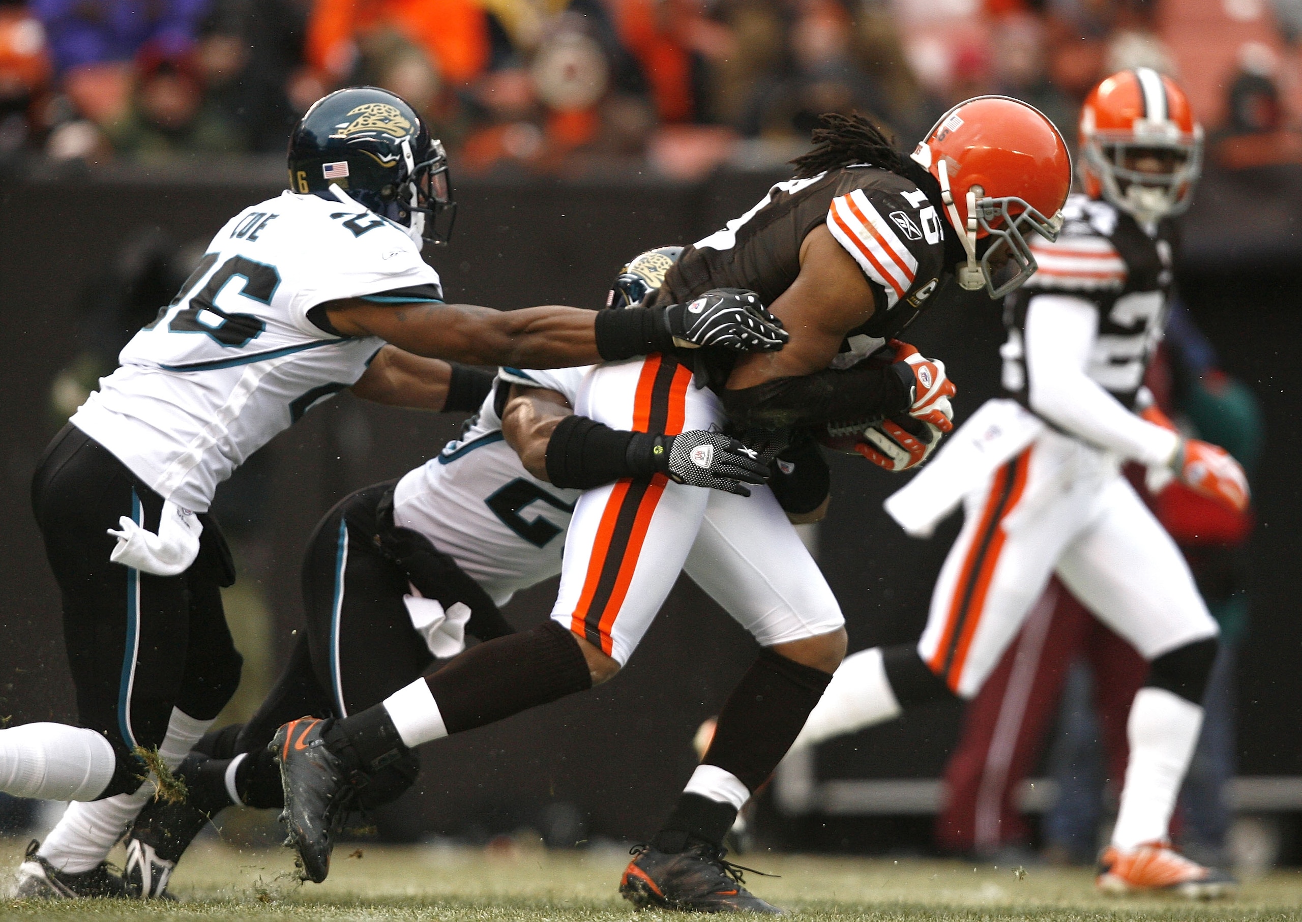 CLEVELAND - JANUARY 03: Joshua Cribbs #16 of the Cleveland Browns runs by Derek Cox #21 and Michael Coe #26 of the Jacksonville Jaguars at Cleveland Browns Stadium on January 3, 2010 in Cleveland, Ohio. (Photo by Matt Sullivan/Getty Images) CLEVELAND - JANUARY 03: Joshua Cribbs #16 of the Cleveland Browns runs by Derek Cox #21 and Michael Coe #26 of the Jacksonville Jaguars at Cleveland Browns Stadium on January 3, 2010 in Cleveland, Ohio. (Photo by Matt Sullivan/Getty Images)