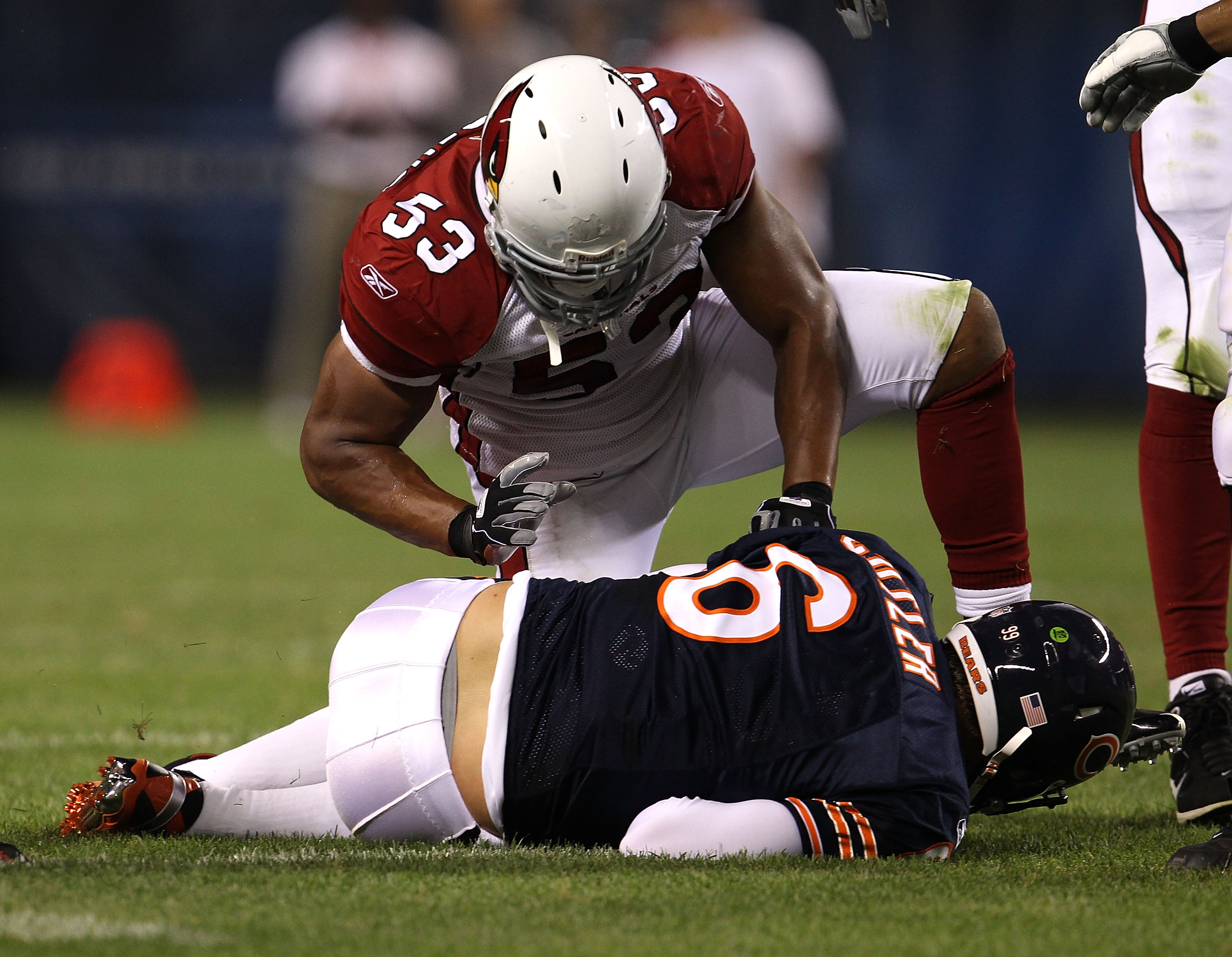 CHICAGO - AUGUST 28: Clark Haggans #53 of the Arizona Cardinals kneels over Jay Cutler #6 of the Chicago Bears after a sack during a preseason game at Soldier Field on August 28, 2010 in Chicago, Illinois. The Cardinals defeated the Bears 14-9. (Photo by 