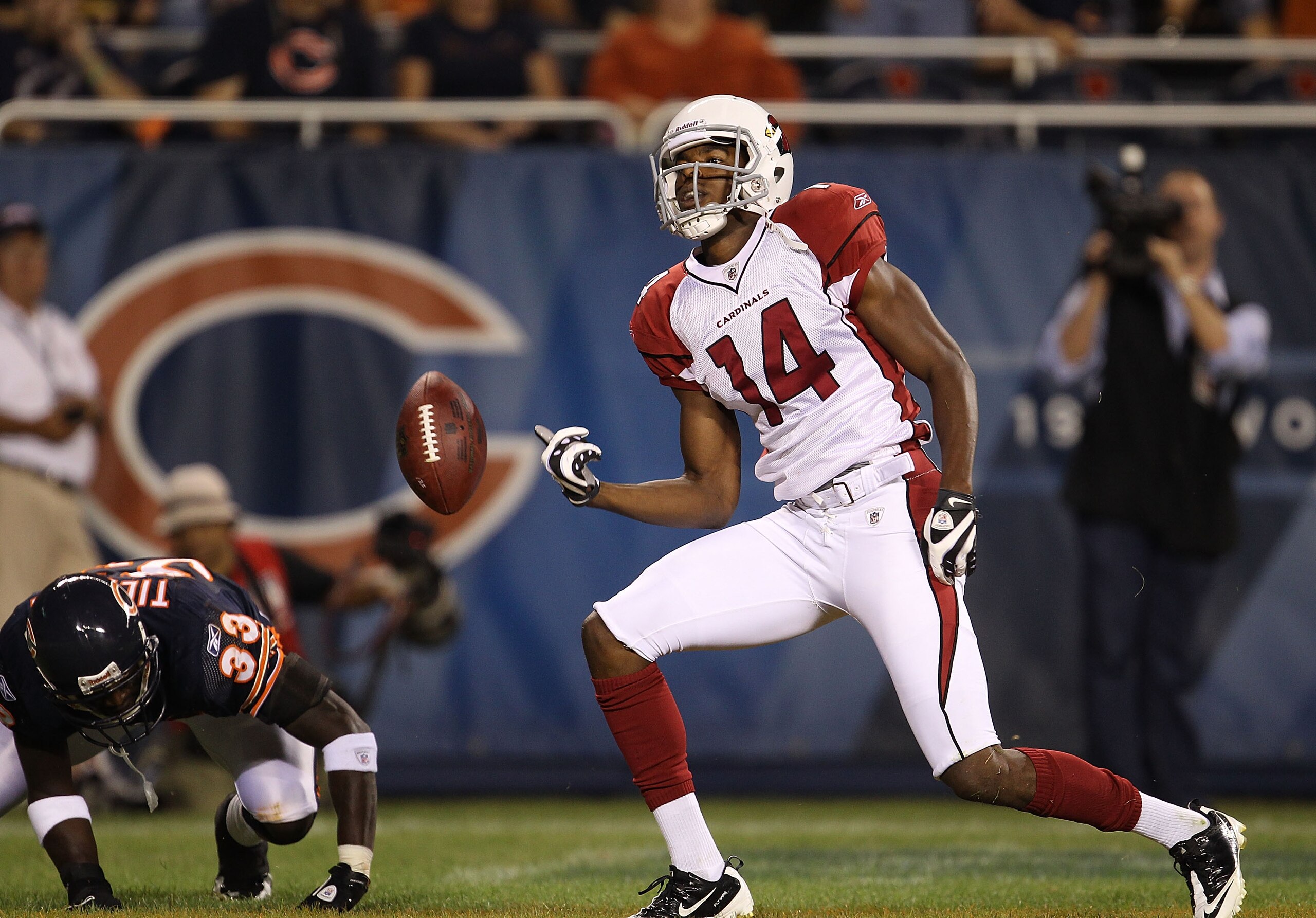 CHICAGO - AUGUST 28: Stephen Williams #14 of the Arizona Cardinals flips the ball after scoring a touchdown as Charles Tillman #33 of the Chicago Bears gets up during a preseason game at Soldier Field on August 28, 2010 in Chicago, Illinois. (Photo by Jon