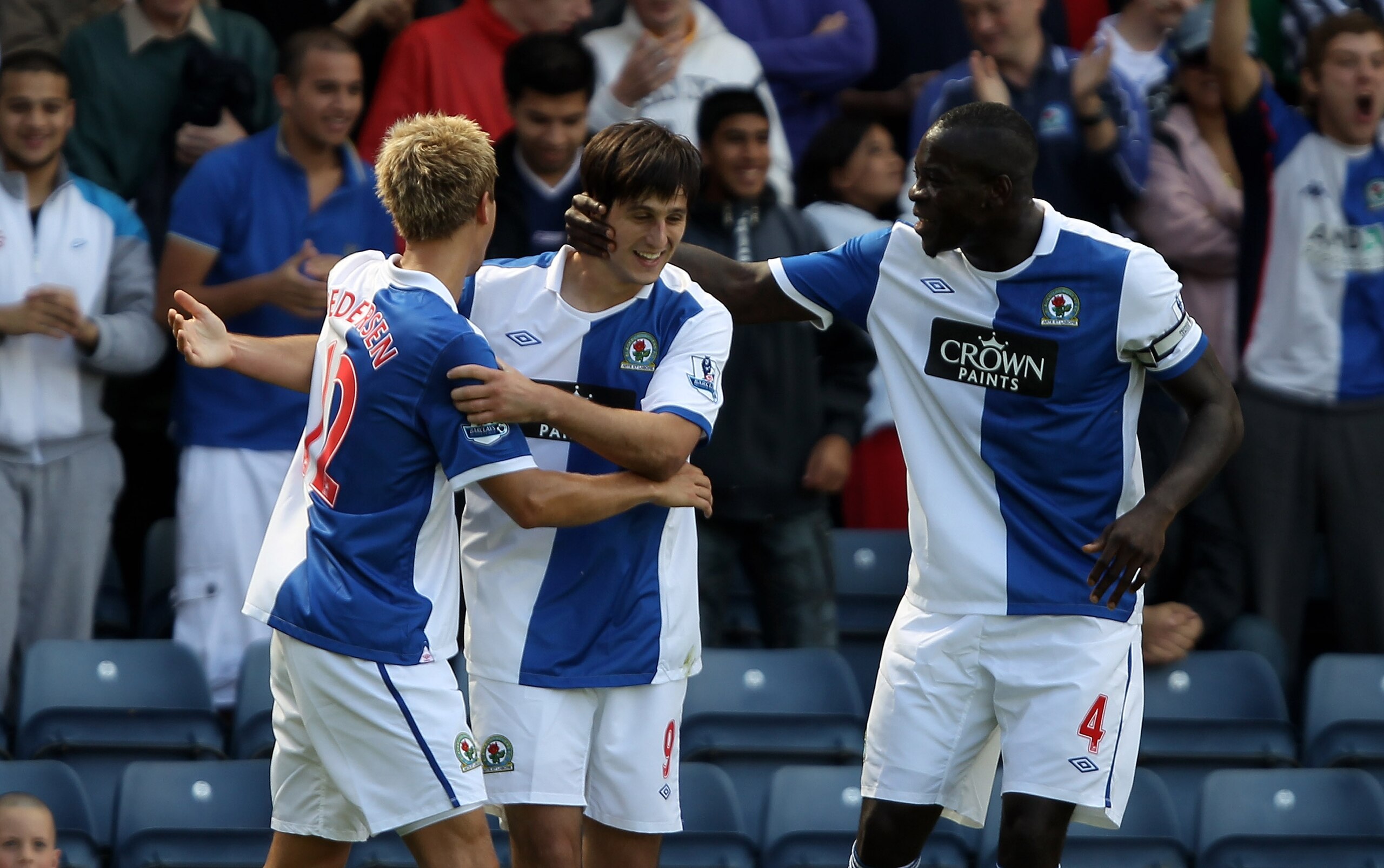 BLACKBURN, ENGLAND - AUGUST 14:  Nikola Kalinic of Blackburn Rovers celebrates with team mates Chris Samba and Morten Gamst Pedersen after scoring the first goal during the Barclays Premier League match between Blackburn Rovers and Everton at Ewood Park o