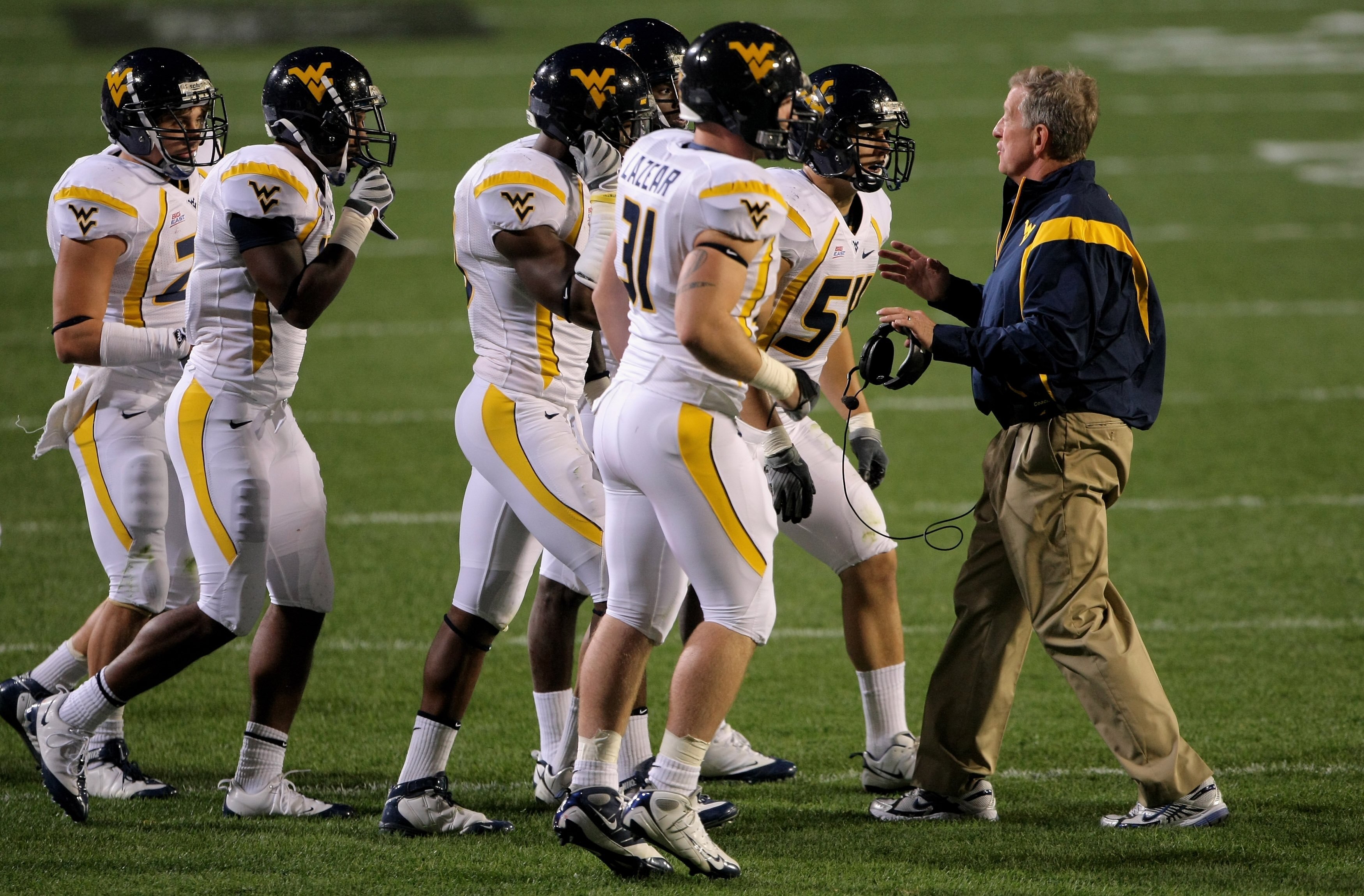 BOULDER, CO - SEPTEMBER 18:  Head coach Bill Stewart of the West Virginia Mountaineers leads his team against the Colorado Buffaloes at Folsom Field on September 18, 2008 in Boulder, Colorado. Colorado defeated West Virginia 17-14 in overtime.  (Photo by