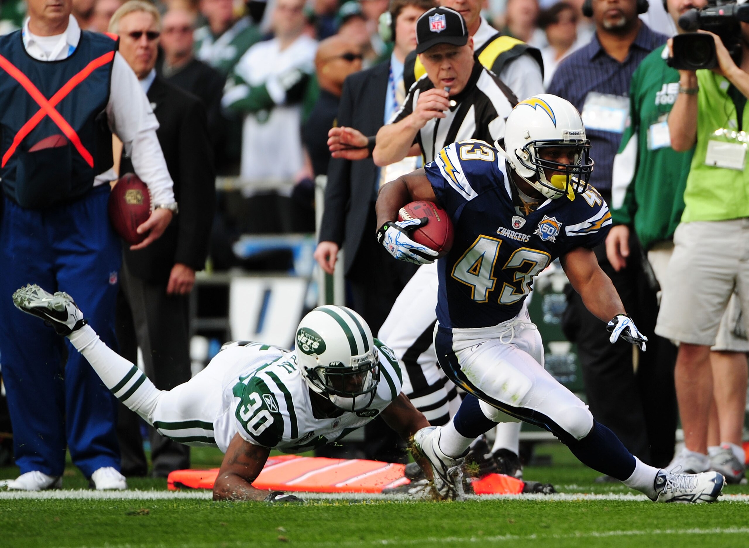 SAN DIEGO - JANUARY 17: Running back Darren Sproles #43 of the San Diego Chargers runs with the ball as cornerback Drew Coleman #30 the New York Jets trys to tackle during the AFC Divisional Playoff Game at Qualcomm Stadium on January 17, 2010 in San Die SAN DIEGO - JANUARY 17: Running back Darren Sproles #43 of the San Diego Chargers runs with the ball as cornerback Drew Coleman #30 the New York Jets trys to tackle during the AFC Divisional Playoff Game at Qualcomm Stadium on January 17, 2010 in San Die