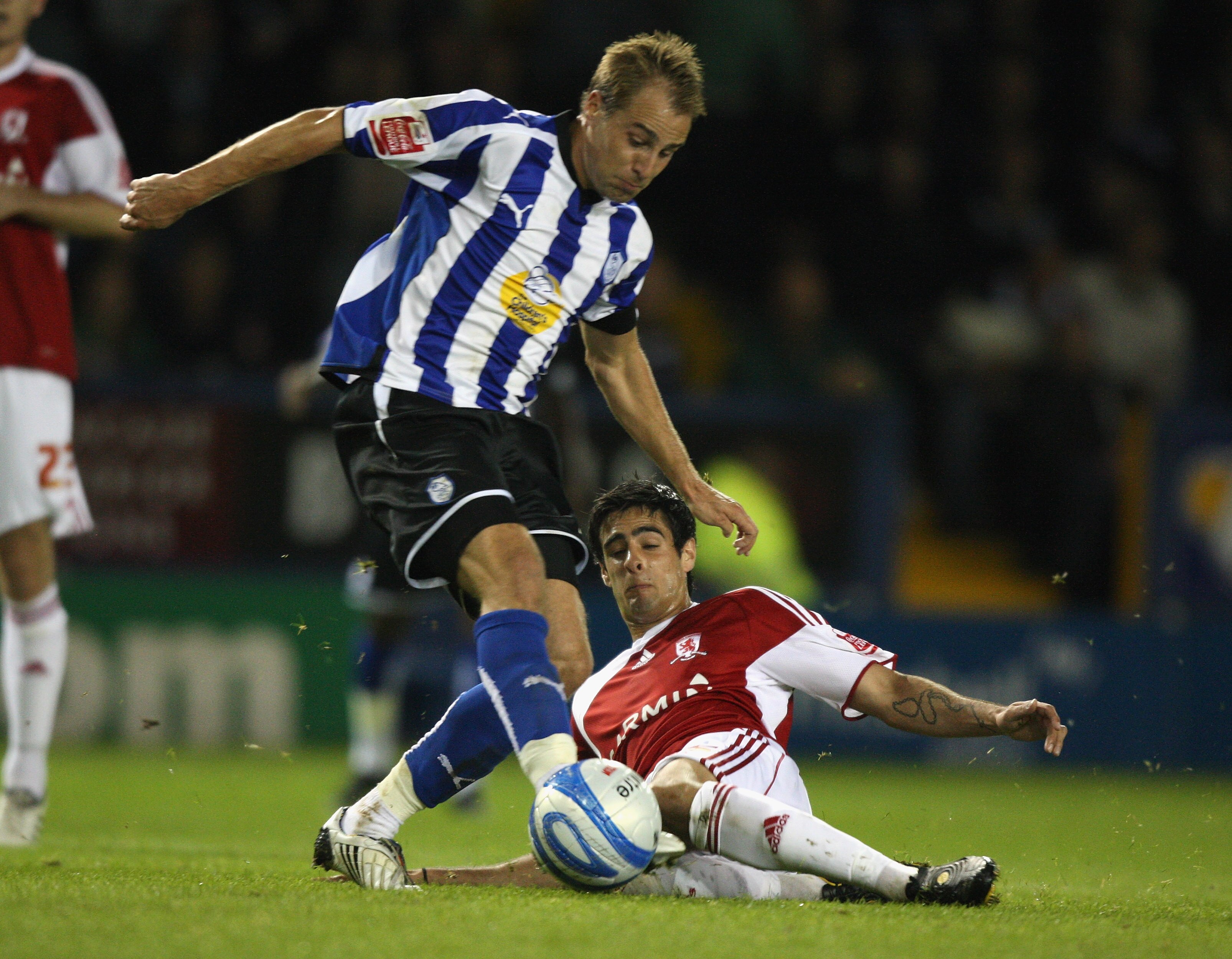 SHEFFIELD, ENGLAND - SEPTEMBER 15:  Luke Varney of Sheffield Wednesday (L) is tackled by Rhys Williams of Middlesbrough during the Coca-Cola Championship match between Sheffield Wednesday and Middlesbrough at Hillsborough on September 15, 2009 in Sheffiel