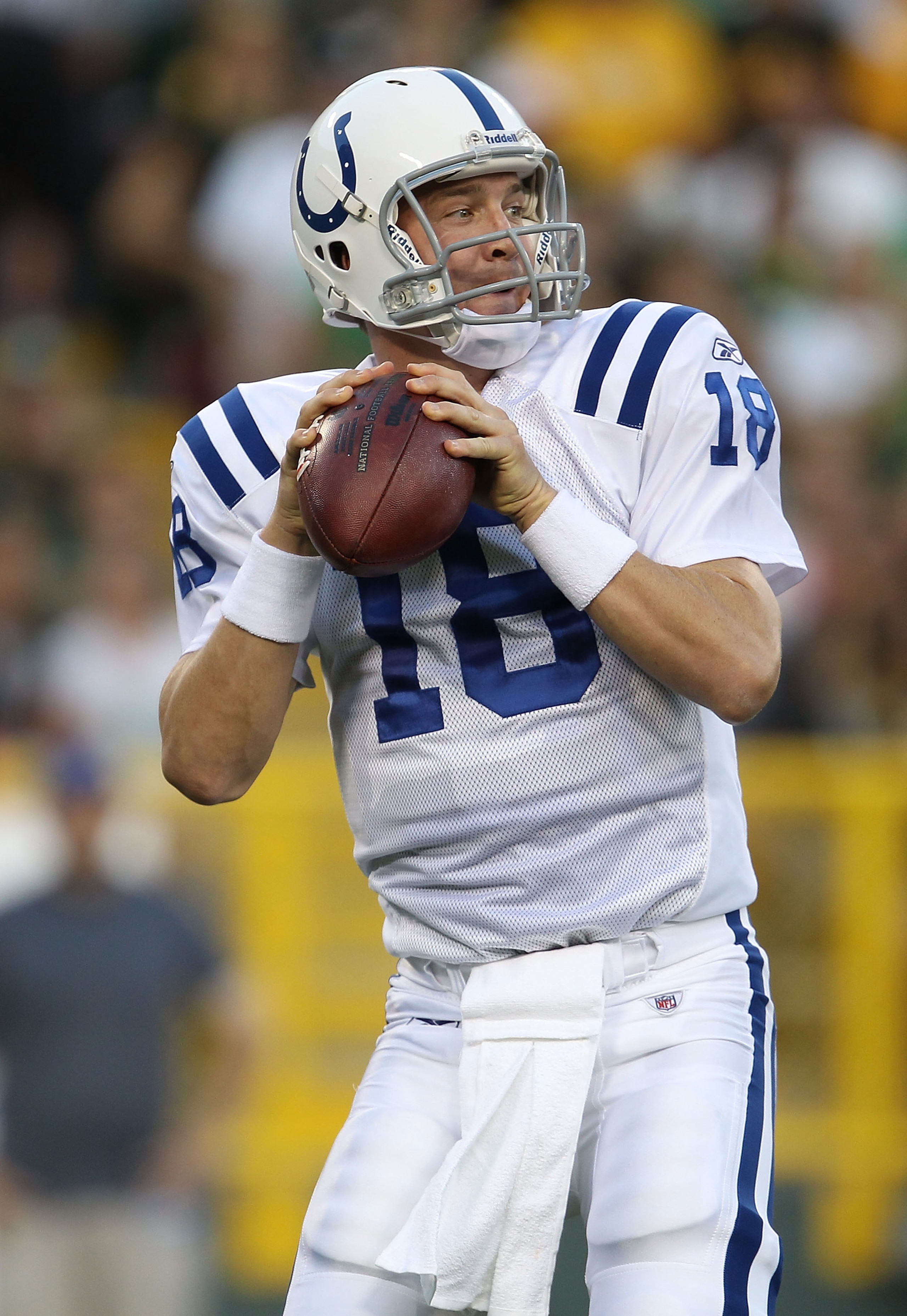 GREEN BAY, WI - AUGUST 26: Peyton Manning #18 of the Indianapolis Colts looks for a receiver against the Green Bay Packers during a preseason game at Lambeau Field on August 26, 2010 in Green Bay, Wisconsin.  The Packers defeated the Colts 59-24. (Photo b