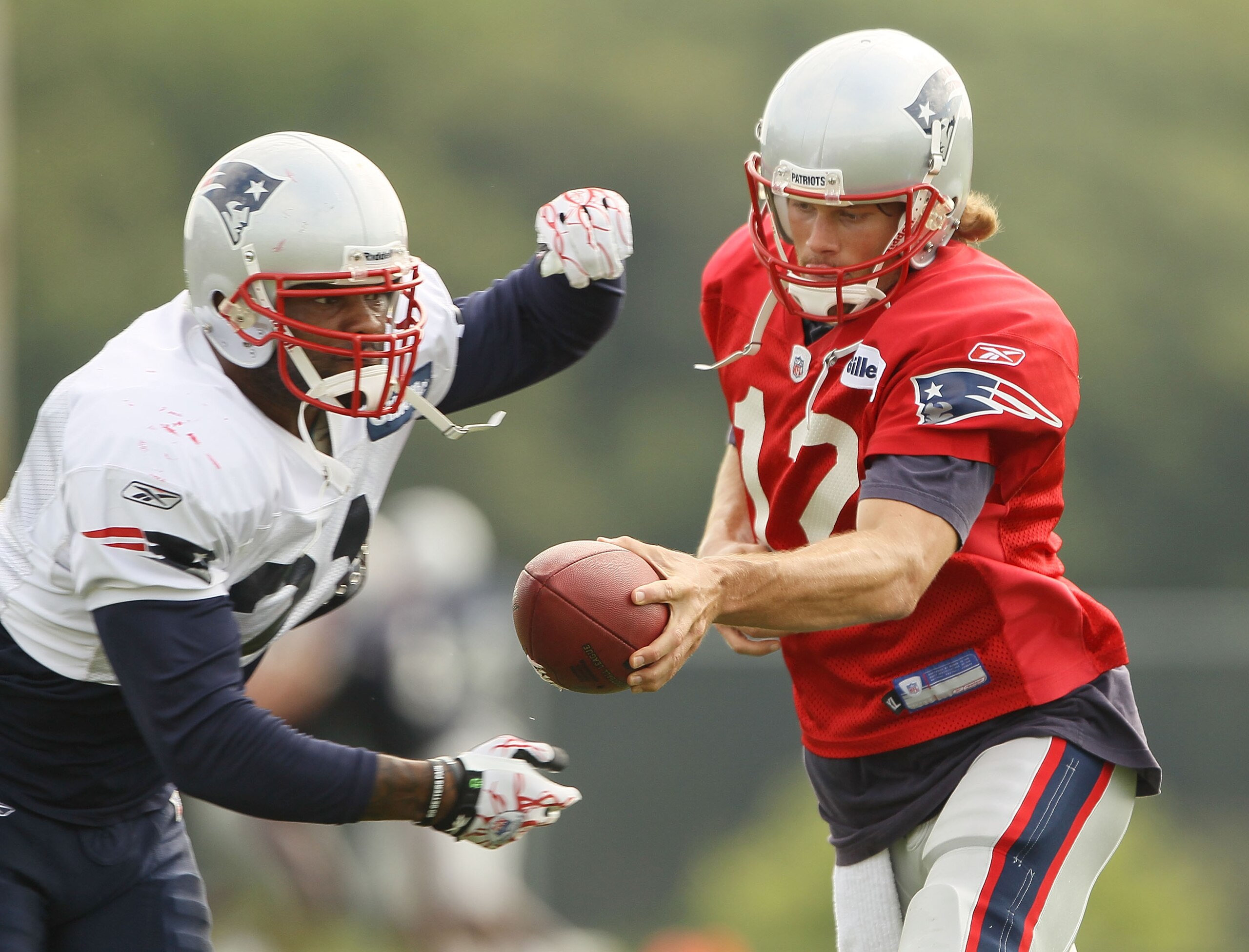 FOXBORO, MA - AUGUST 02: Tom Brady #12 f the New England Patriots fakes a handoff to Fred Taylor #21 during training camp on August 2, 2010 at Gillette Stadium in Foxboro, Massachusetts. (Photo by Elsa/Getty Images) FOXBORO, MA - AUGUST 02: Tom Brady #12 f the New England Patriots fakes a handoff to Fred Taylor #21 during training camp on August 2, 2010 at Gillette Stadium in Foxboro, Massachusetts. (Photo by Elsa/Getty Images)