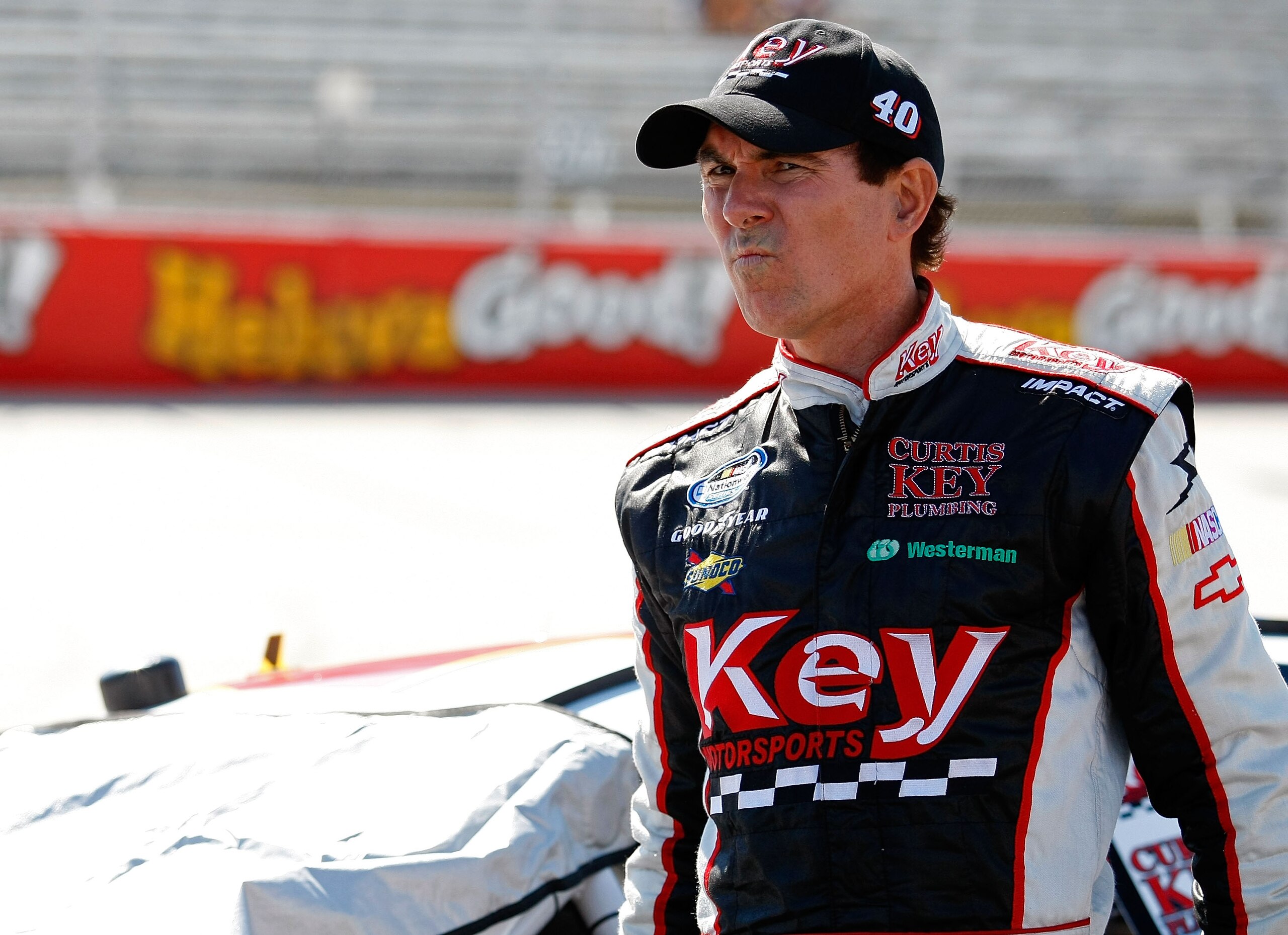 DOVER, DE - MAY 15:  Mike Bliss, driver of the #40 Key Motorsports Chevrolet, walks on the grid during qualifying for the NASCAR Nationwide Series Heluva Good 200 at Dover International Speedway on May 15, 2010 in Dover, Delaware.  (Photo by Geoff Burke/G