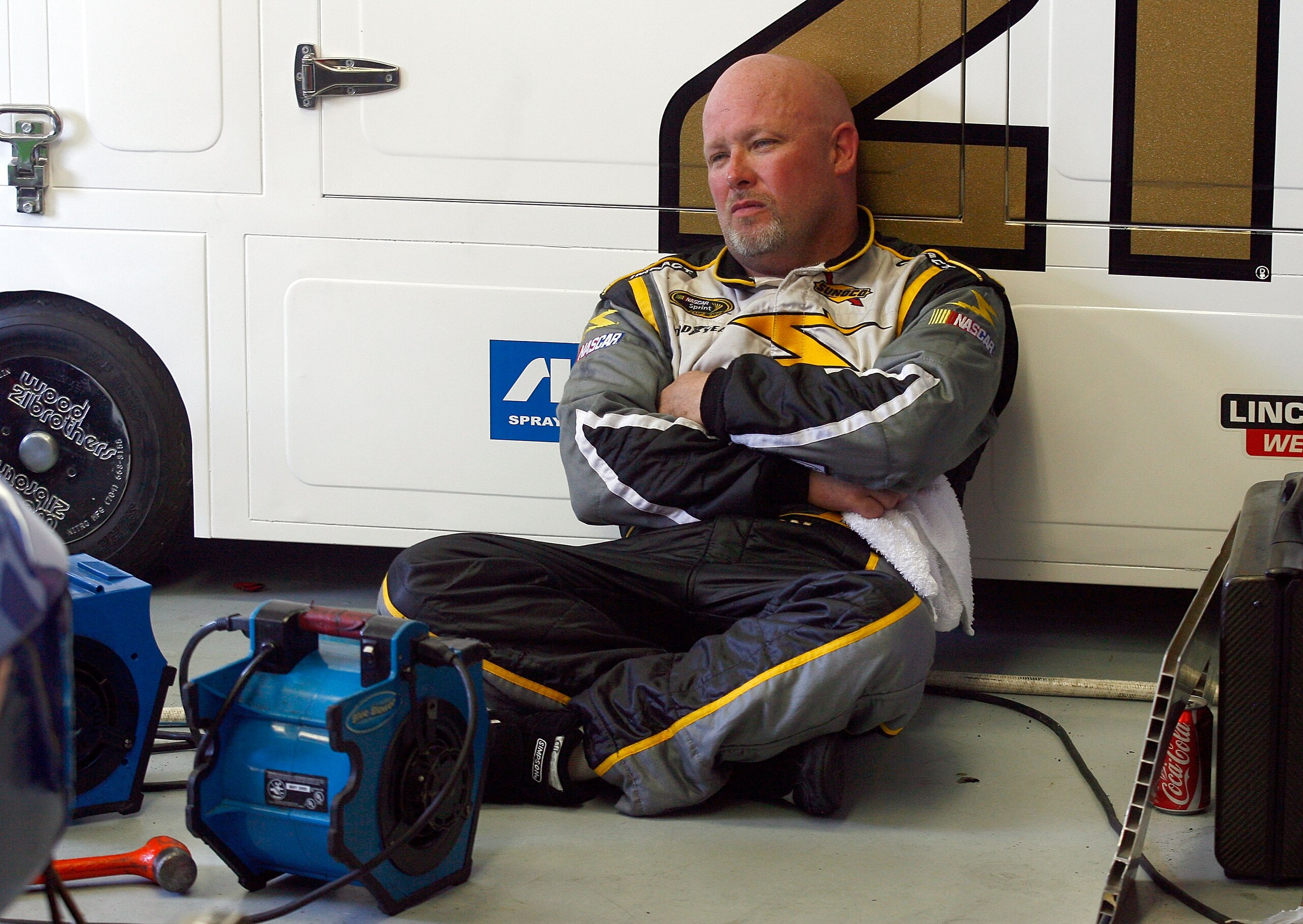 INDIANAPOLIS - JULY 24:  Todd Bodine, driver of the #64 Fred's Hometown Discount Store Toyota, sits in the garage during practice for the NASCAR Sprint Cup Series Brickyard 400 at Indianapolis Motor Speedway on July 24, 2010 in Indianapolis, Indiana.  (Ph