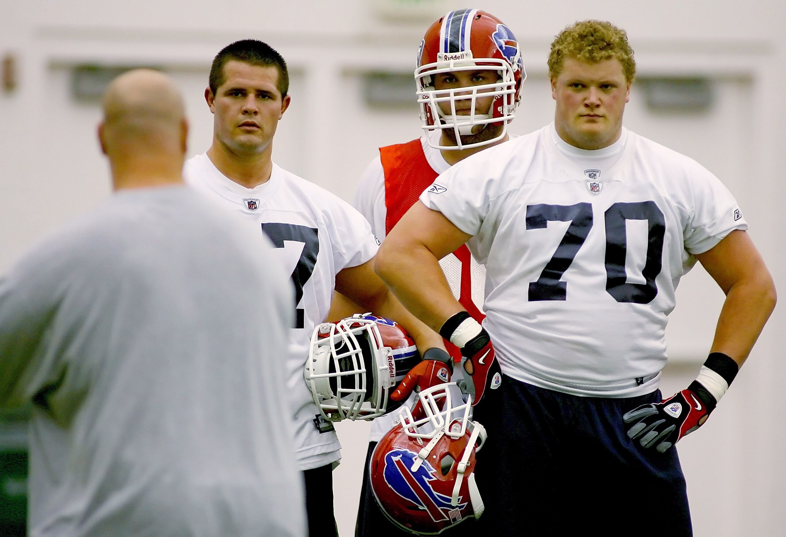 ORCHARD PARK, NY - MAY 01: Andy Levitre #67 and Eric Wood #70 of the Buffalo Bills listen to lineman coach Sean Kugler during Buffalo Bills Minicamp at Buffalo Bills Fieldhouse on May 1, 2009 in Orchard Park, New York.  (Photo by Rick Stewart/Getty Images
