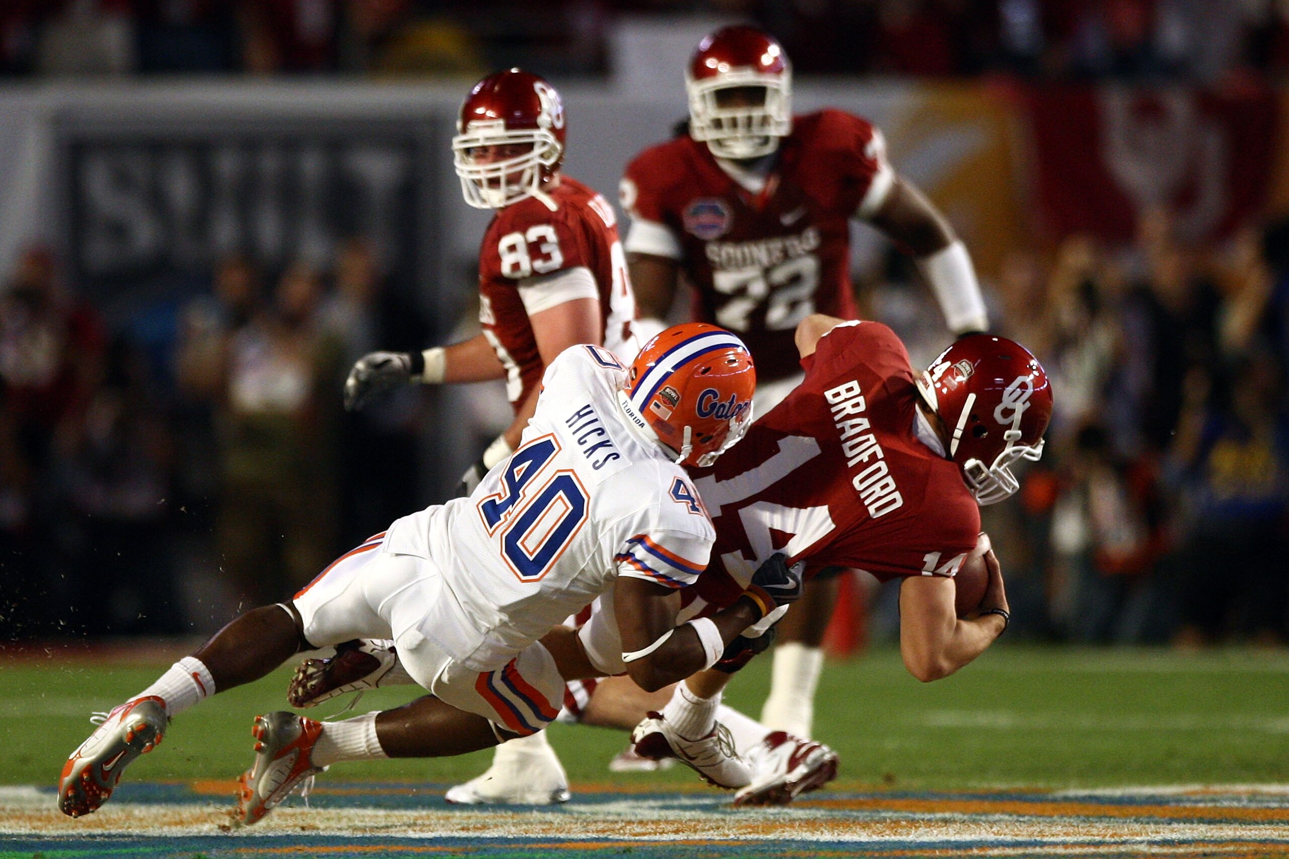 MIAMI - JANUARY 08:  Sam Bradford #14 of the Oklahoma Sooners gets sacked by Brandon Hicks #40 of the Florida Gators during the FedEx BCS National Championship Game at Dolphin Stadium on January 8, 2009 in Miami, Florida.  (Photo by Donald Miralle/Getty I