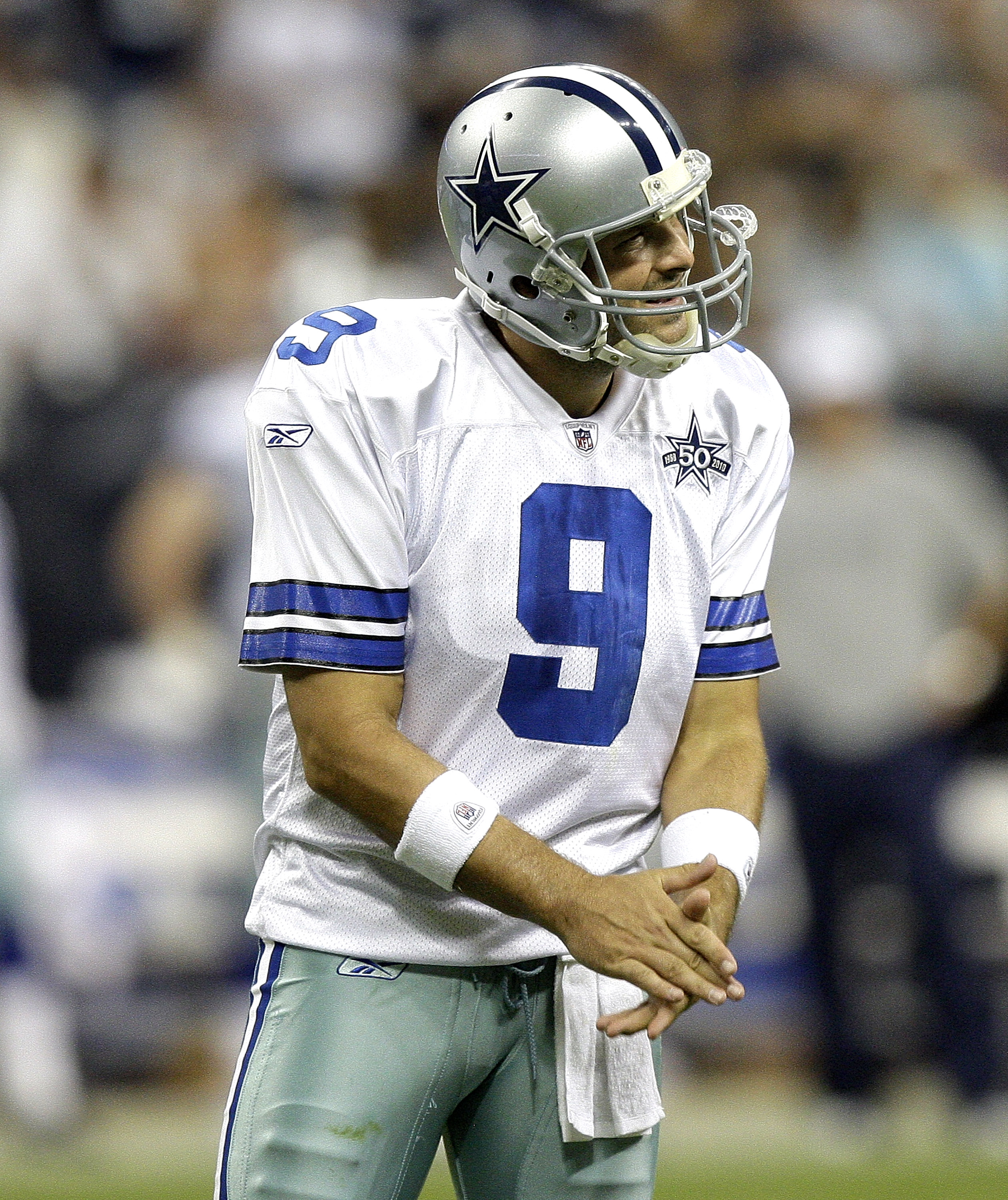 HOUSTON - AUGUST 28: Quarterback Tony Romo #9 of the Dallas Cowboys encourages his offensive line after a penalty was called on the play during a football game against the Houston Texans at Reliant Stadium on August 28, 2010 in Houston, Texas. Houston won