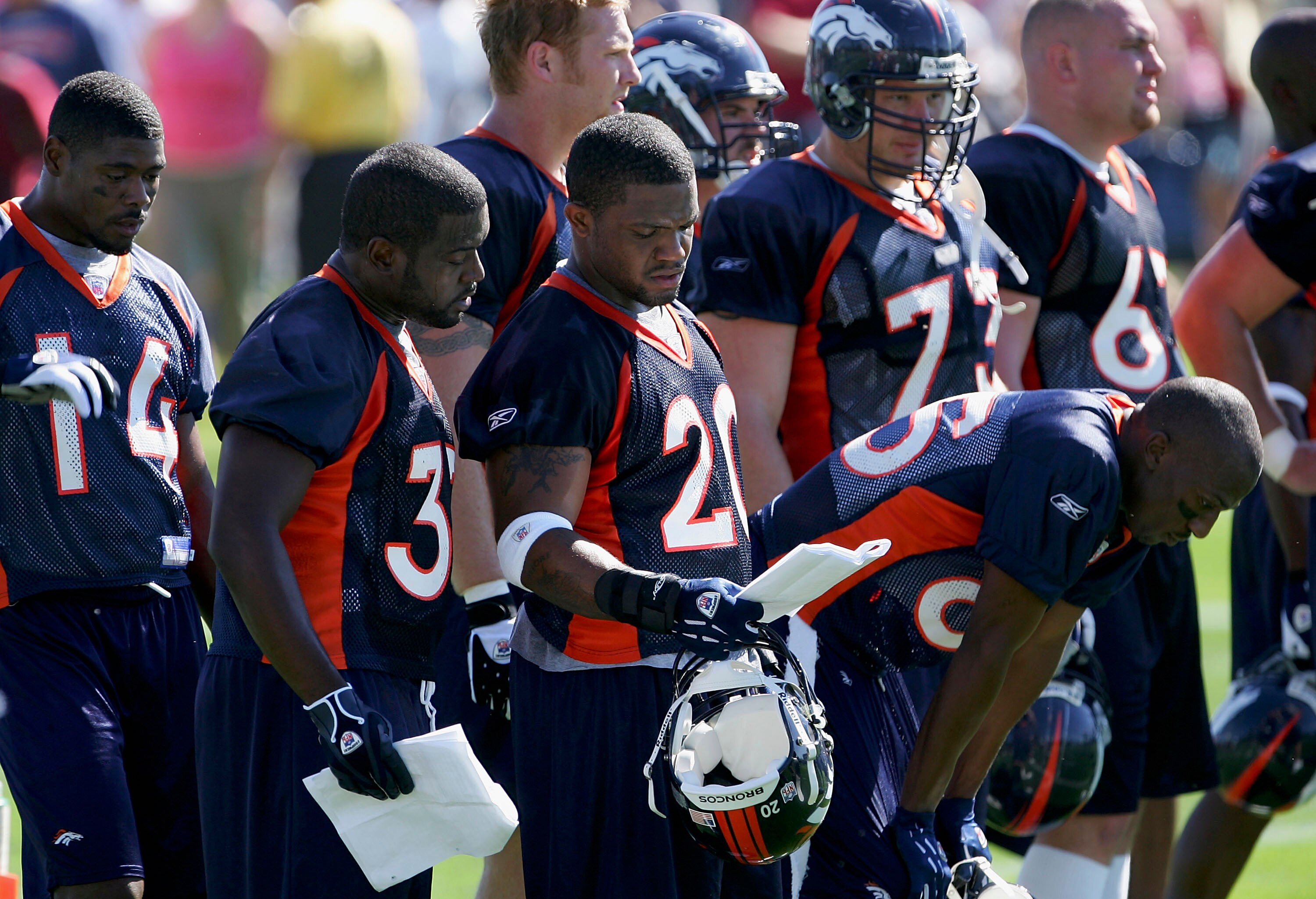 ENGLEWOOD,CO  - JULY 29:  Running backs Ron Dayne #33 and Maurice Clarett #20 of the Denver Broncos review the play book during drills on the first day of Training Camp at the Broncos Training Facility on July 29, 2005 in Englewood, Colorado. (Photo by Do