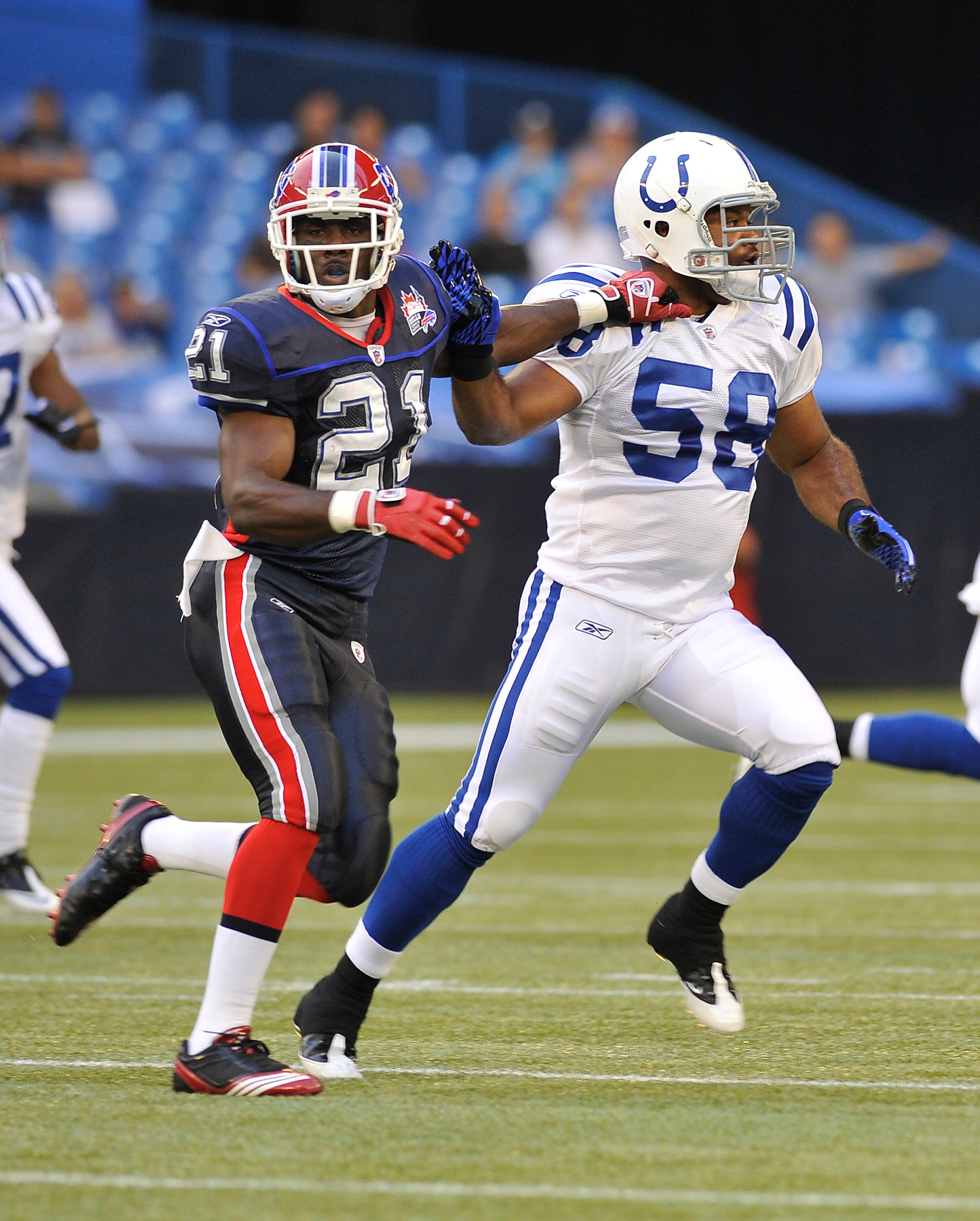TORONTO, CANADA - AUGUST 19: C.J. Spiller #21 of the Buffalo Bills runs with Gary Brackett #58 of the Indianapolis Colts during game action August 19, 2010 at the Rogers Centre in Toronto, Ontario, Canada. (Photo by Brad White/Getty Images)