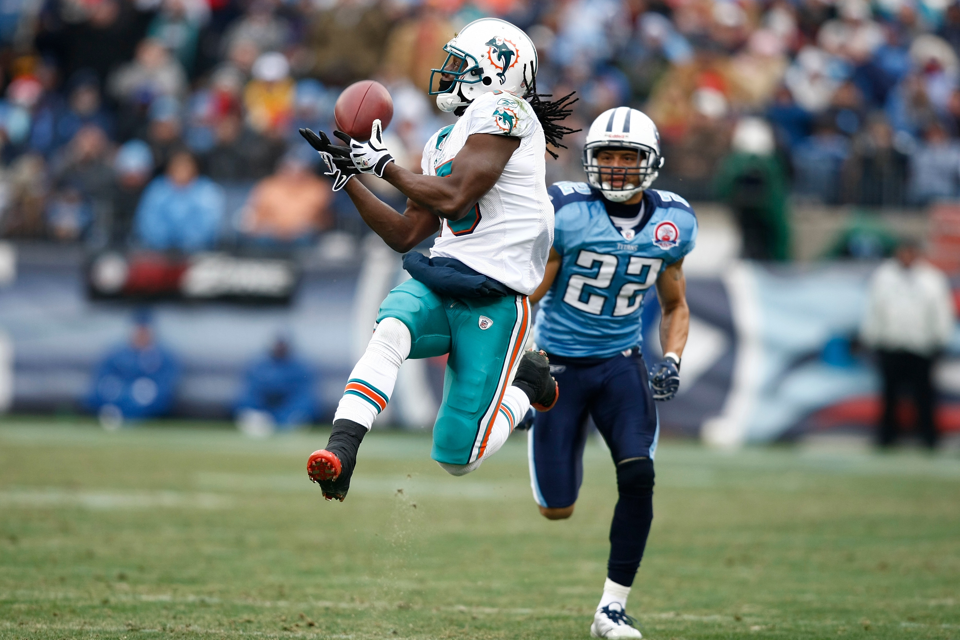 NASHVILLE, TN - DECEMBER 20: Davone Bess #15 of the Miami Dolphins catches a pass behind Vincent Fuller #22 of the Tennessee Titans at LP Field on December 20, 2009 in Nashville, Tennessee. The Titans defeated the Dolphins 27-24 in overtime. (Photo by Joe