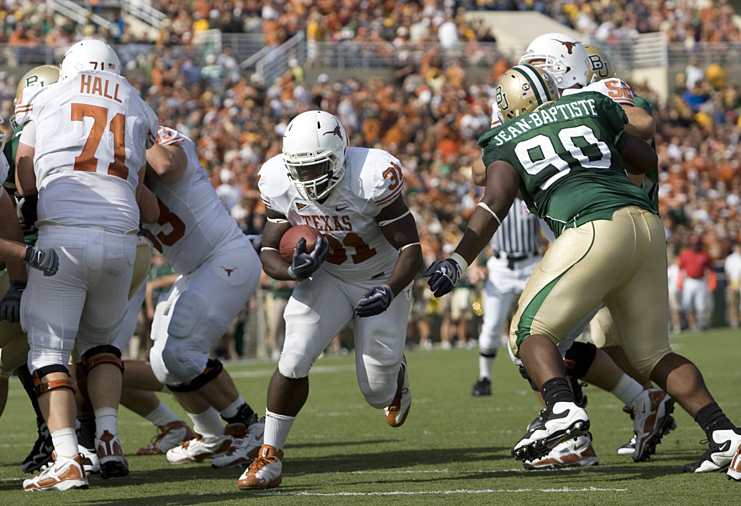 WACO, TX - NOVEMBER 14:  Running back Cody Johnson #31 of the Texas Longhorns carries the ball into the end zone during the first half against tackle Nicolas Jean-Baptiste #90 of the Baylor Bears on November 14, 2009 at Floyd Casey Stadium in Waco, Texas.
